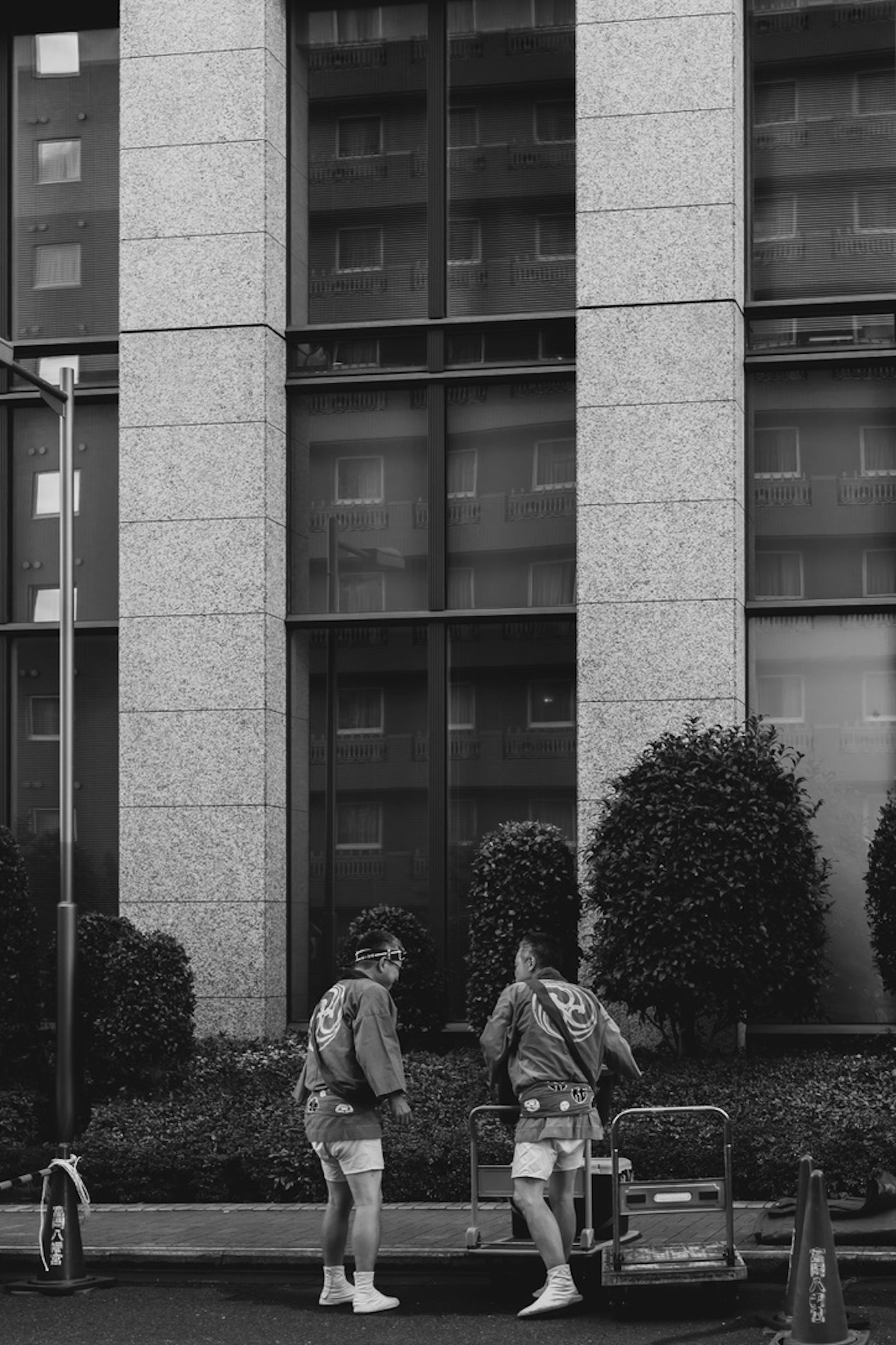 Deux travailleurs discutant devant un bâtiment