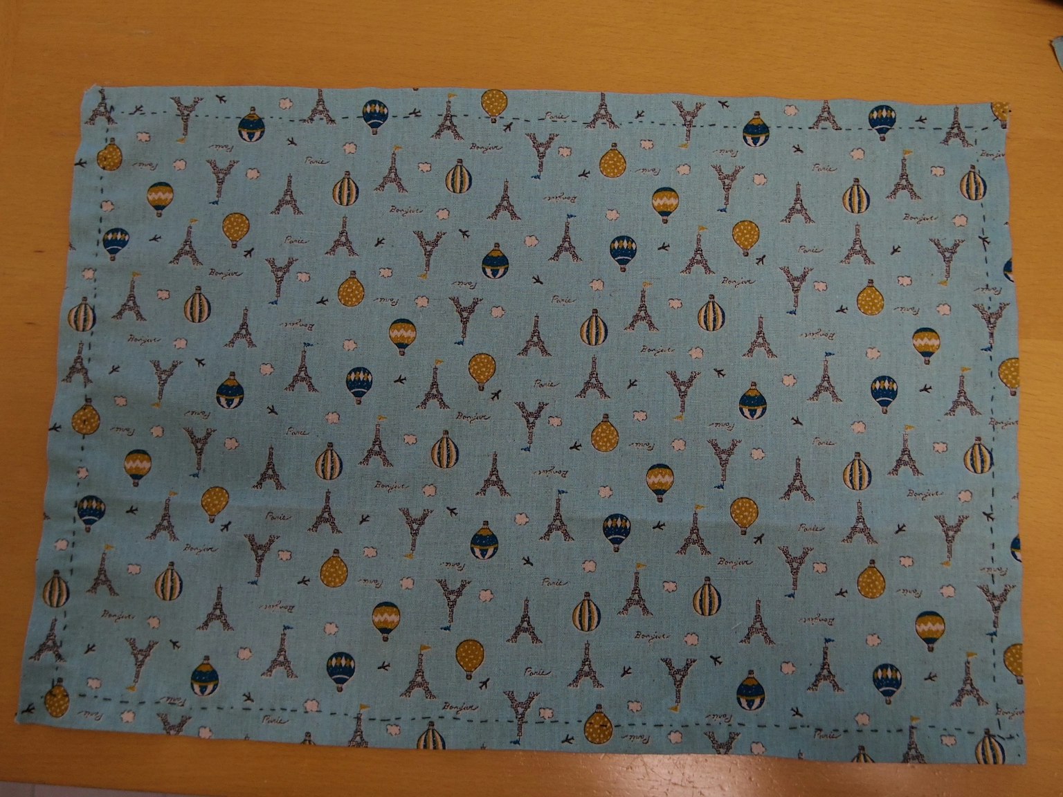 Blue fabric with Eiffel Tower and hot air balloon pattern