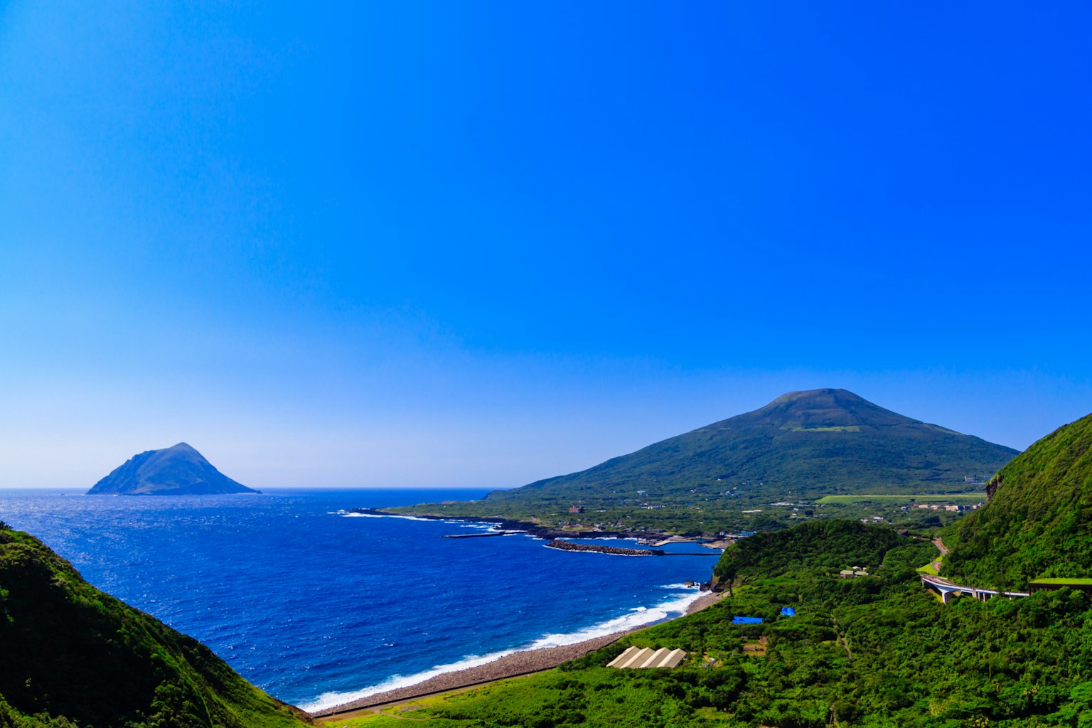 Beautiful landscape of mountains surrounded by blue sky and sea