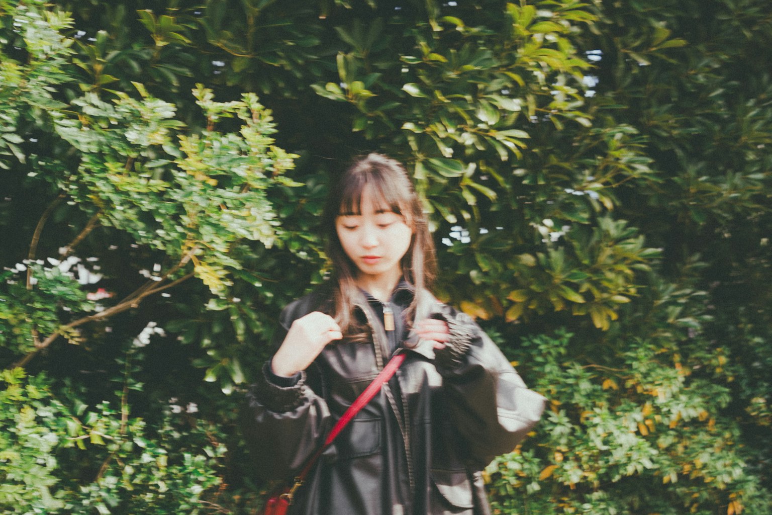 Portrait of a woman standing in front of a green background