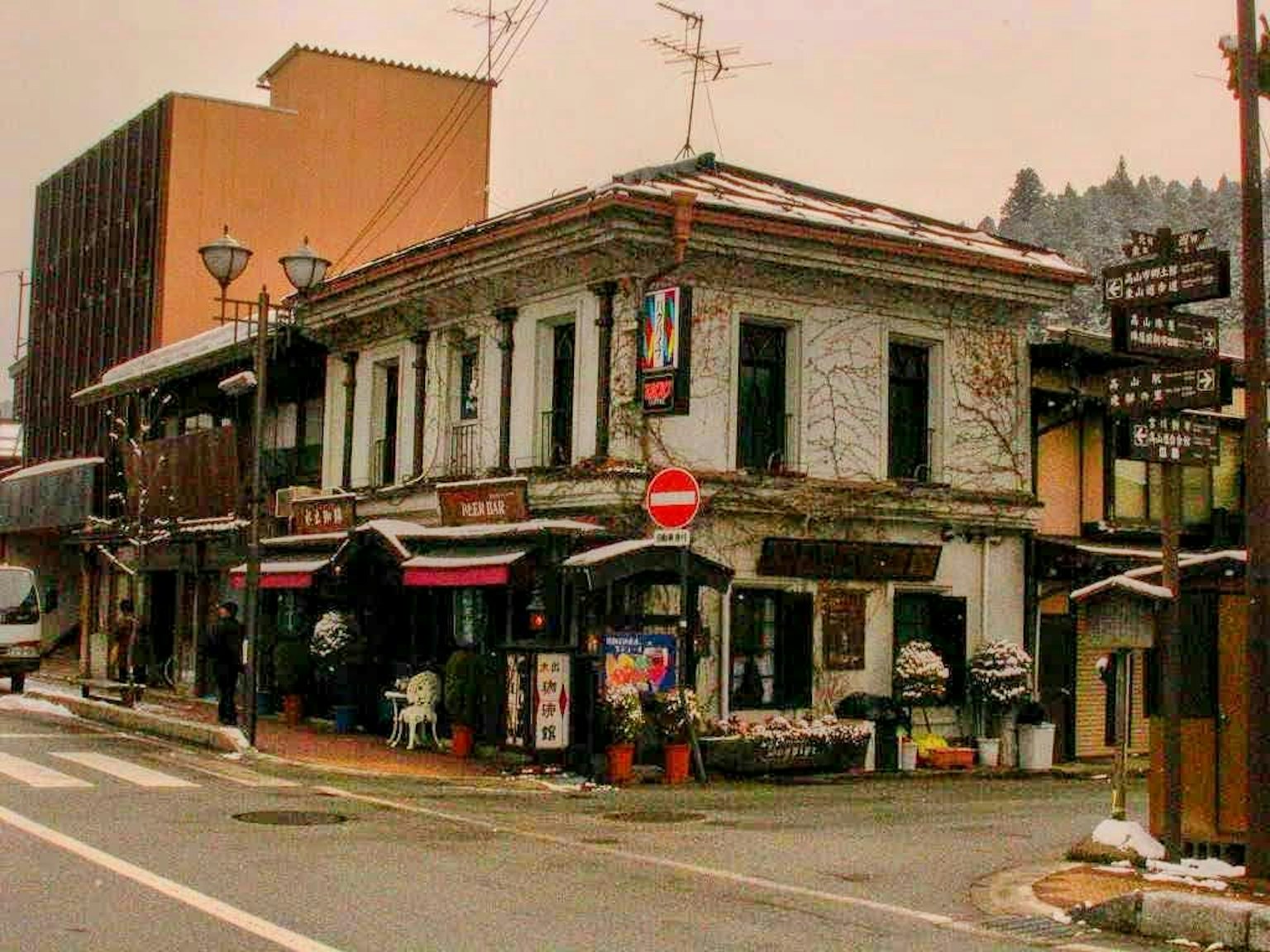 Old building and shops on a snowy street corner
