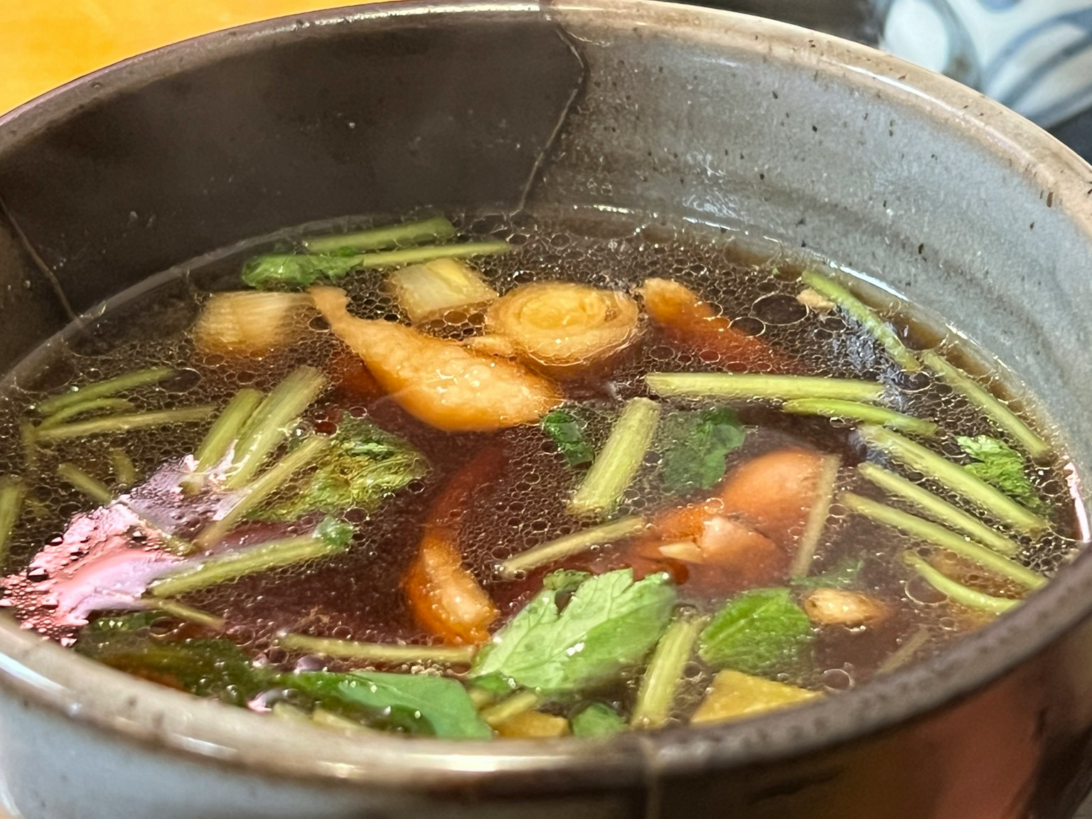 A warm soup pot filled with fresh herbs and spices