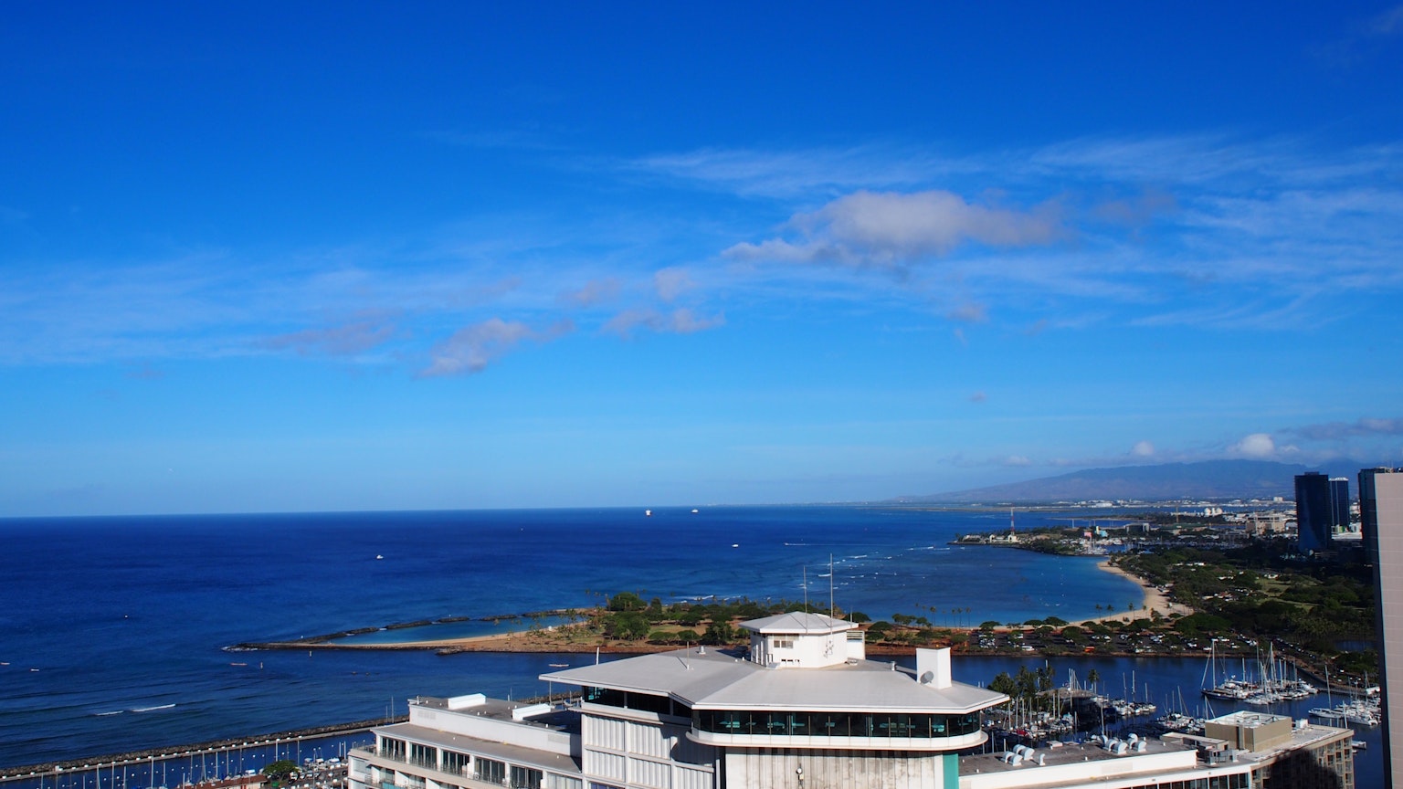 Beautiful view of blue sky and ocean with high-rise buildings and coastline