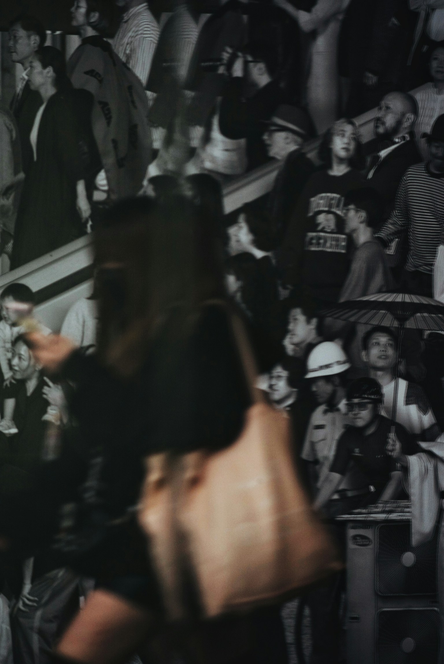 A bustling crowd in a busy urban setting with people moving and interacting