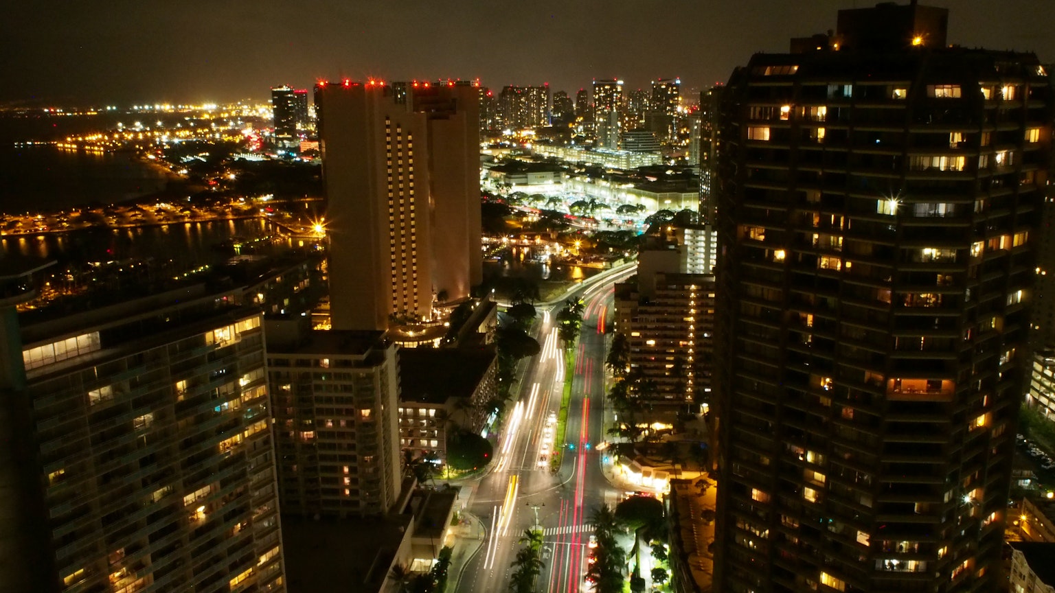 Night view of city skyline with illuminated buildings and busy streets