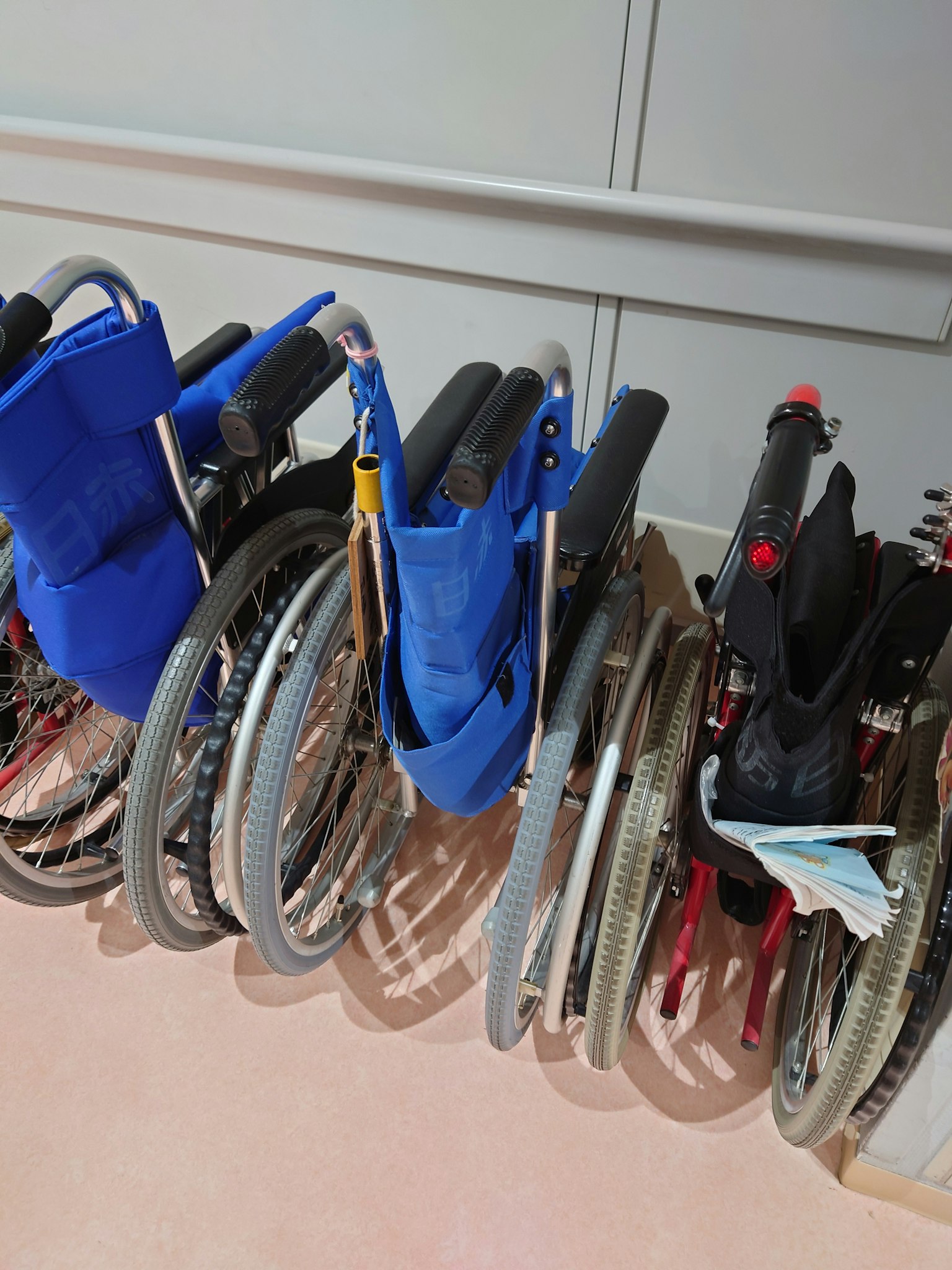 A row of wheelchairs in blue and black colors