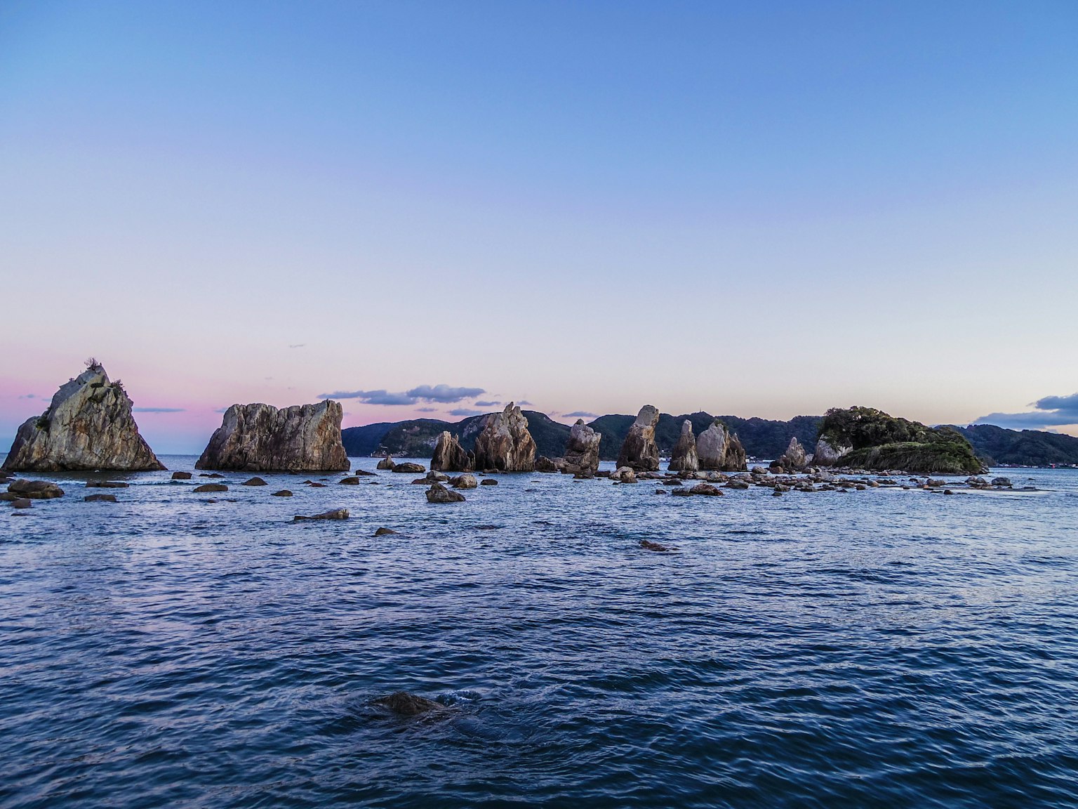 Magnifique coucher de soleil sur une côte rocheuse avec mer calme