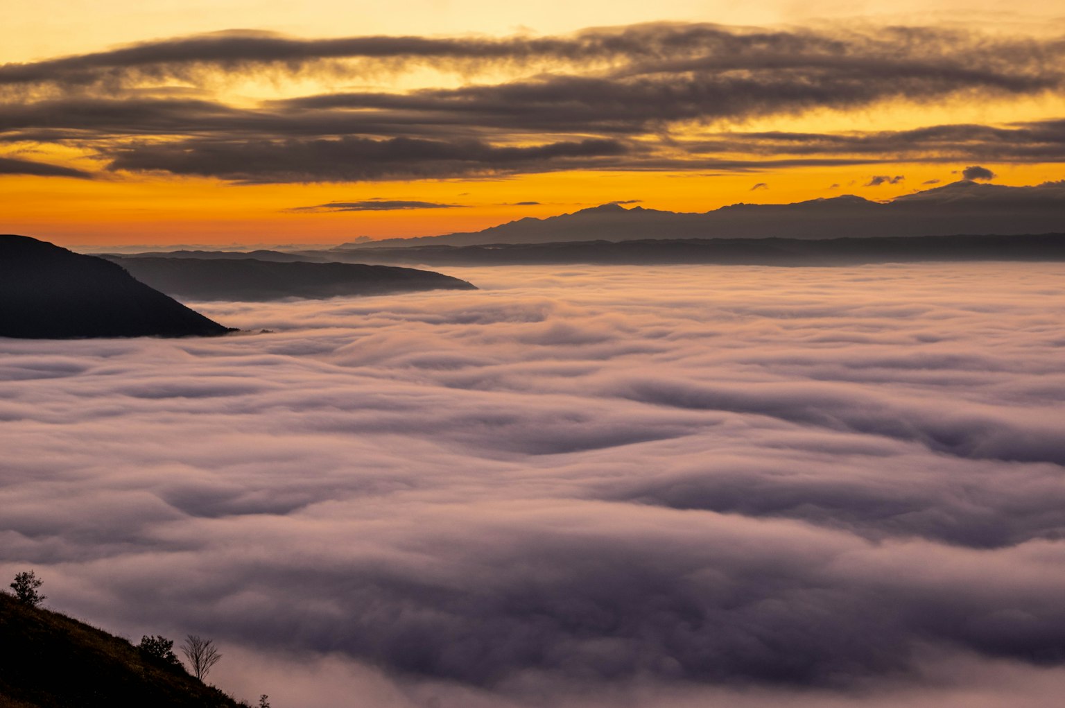 Stunning view of a sea of clouds and mountains during sunset
