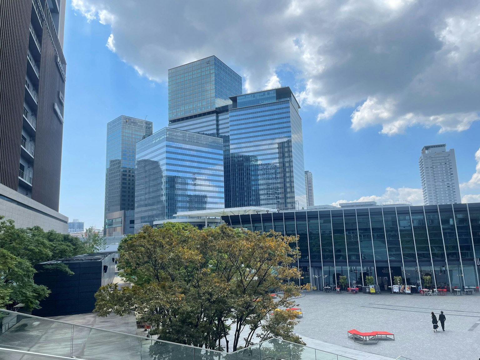 Urban skyline with modern skyscrapers and open plaza under blue sky