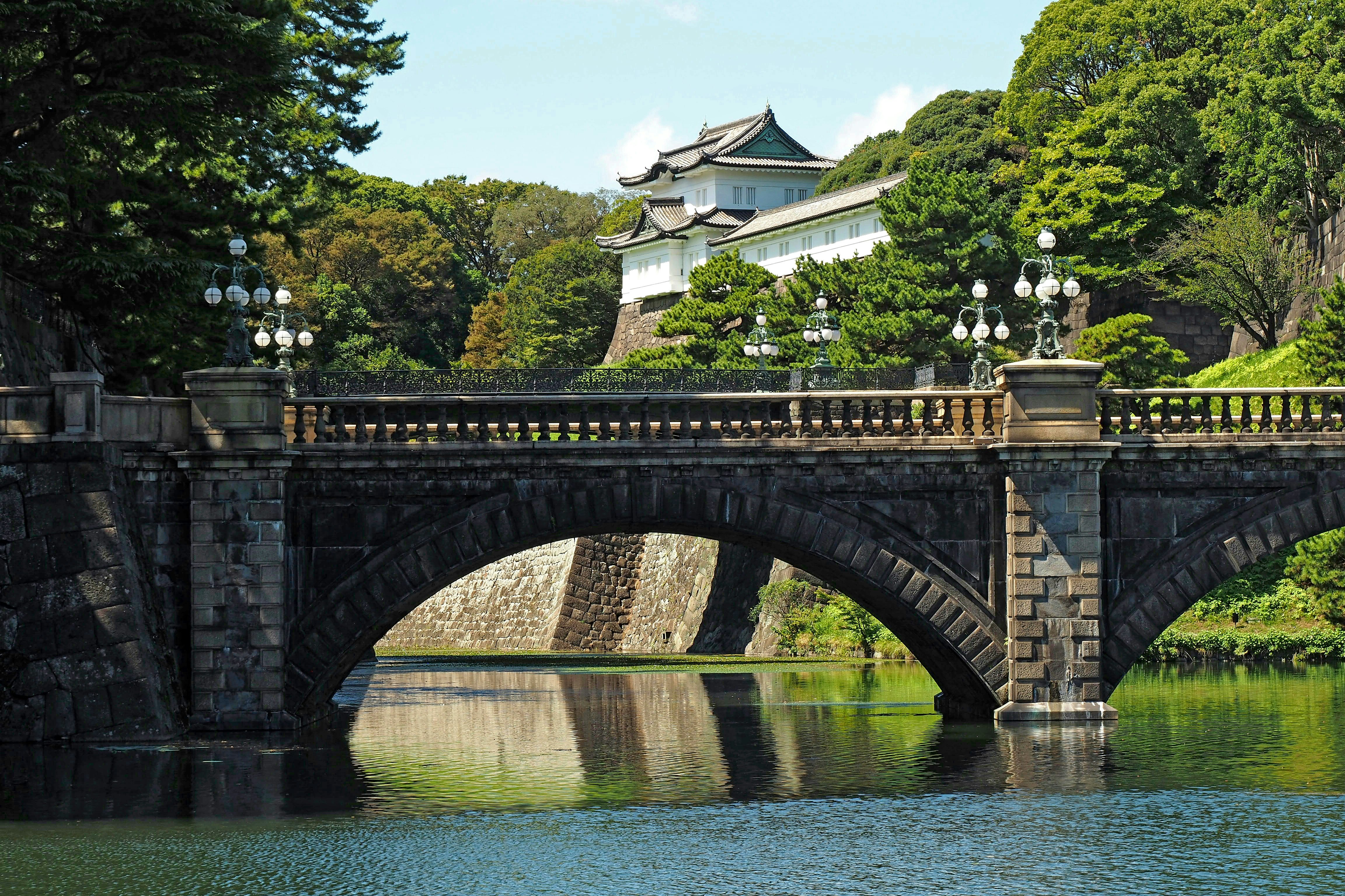 石拱橋跨過花園池塘的景色