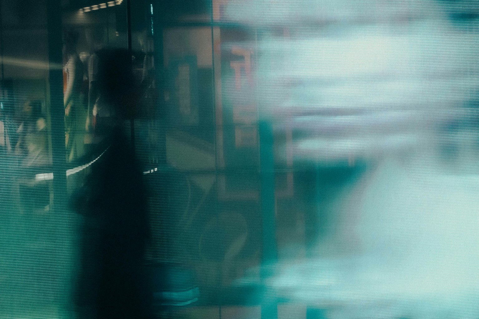 Blurred urban scene with overlapping silhouettes of a person