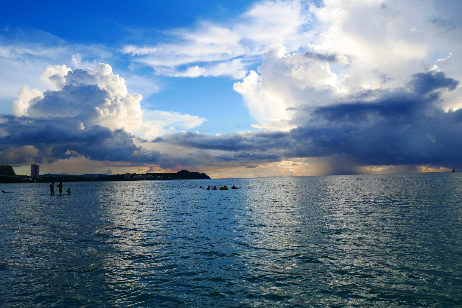 Beautiful landscape of blue sea and sky with clouds and people