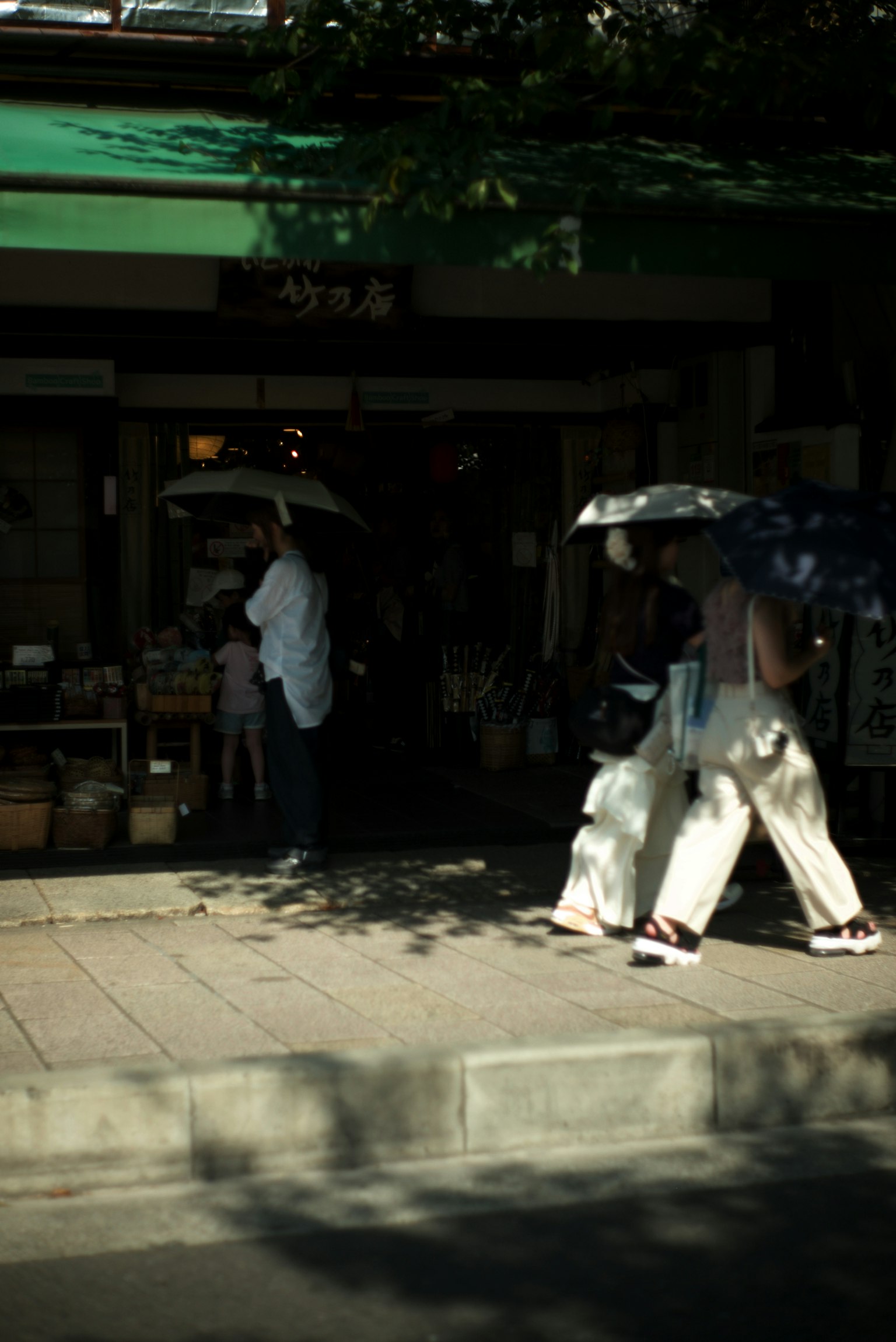 人们在商店前面打着伞走路