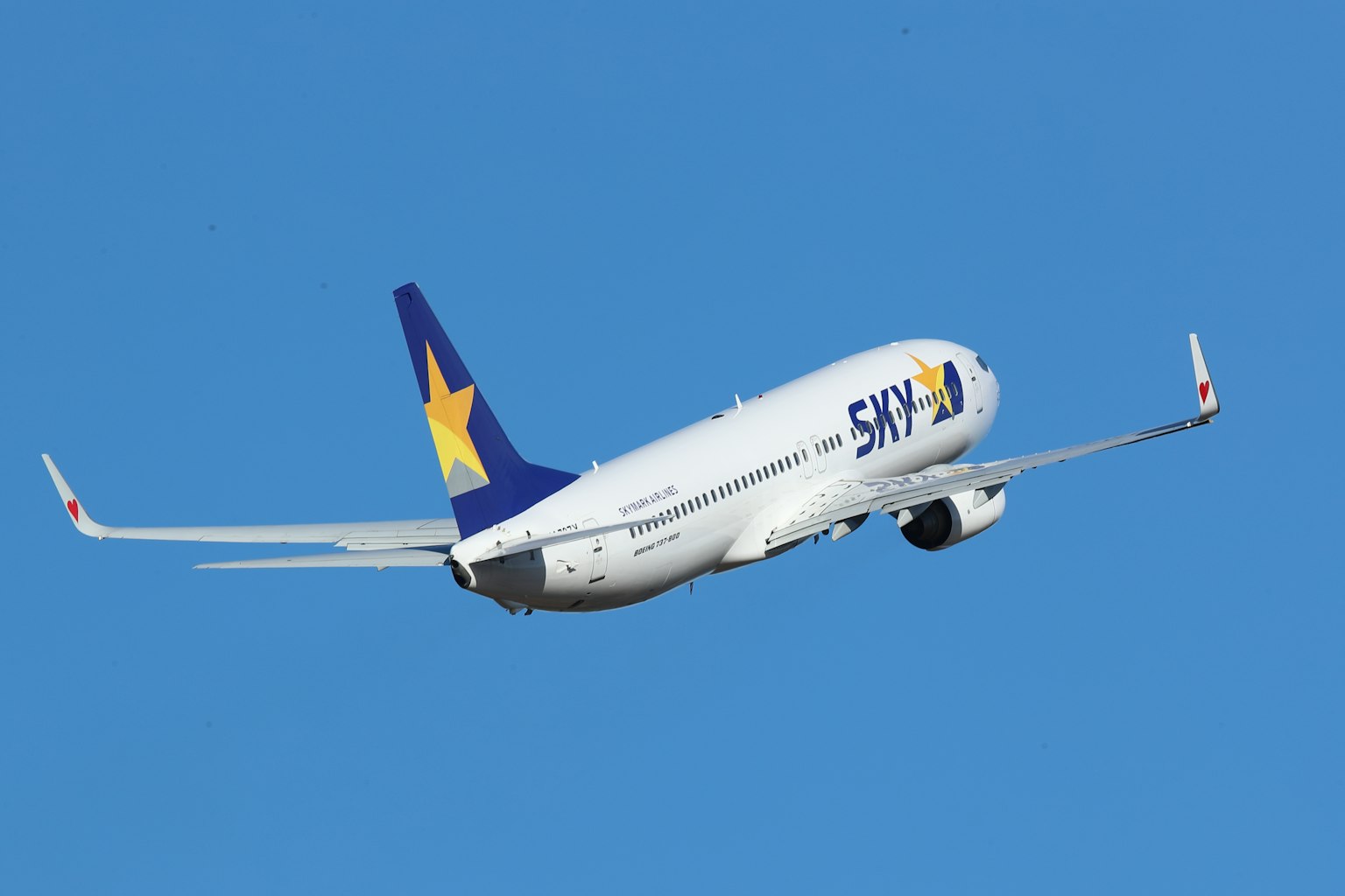 Airplane flying in a blue sky with a star logo