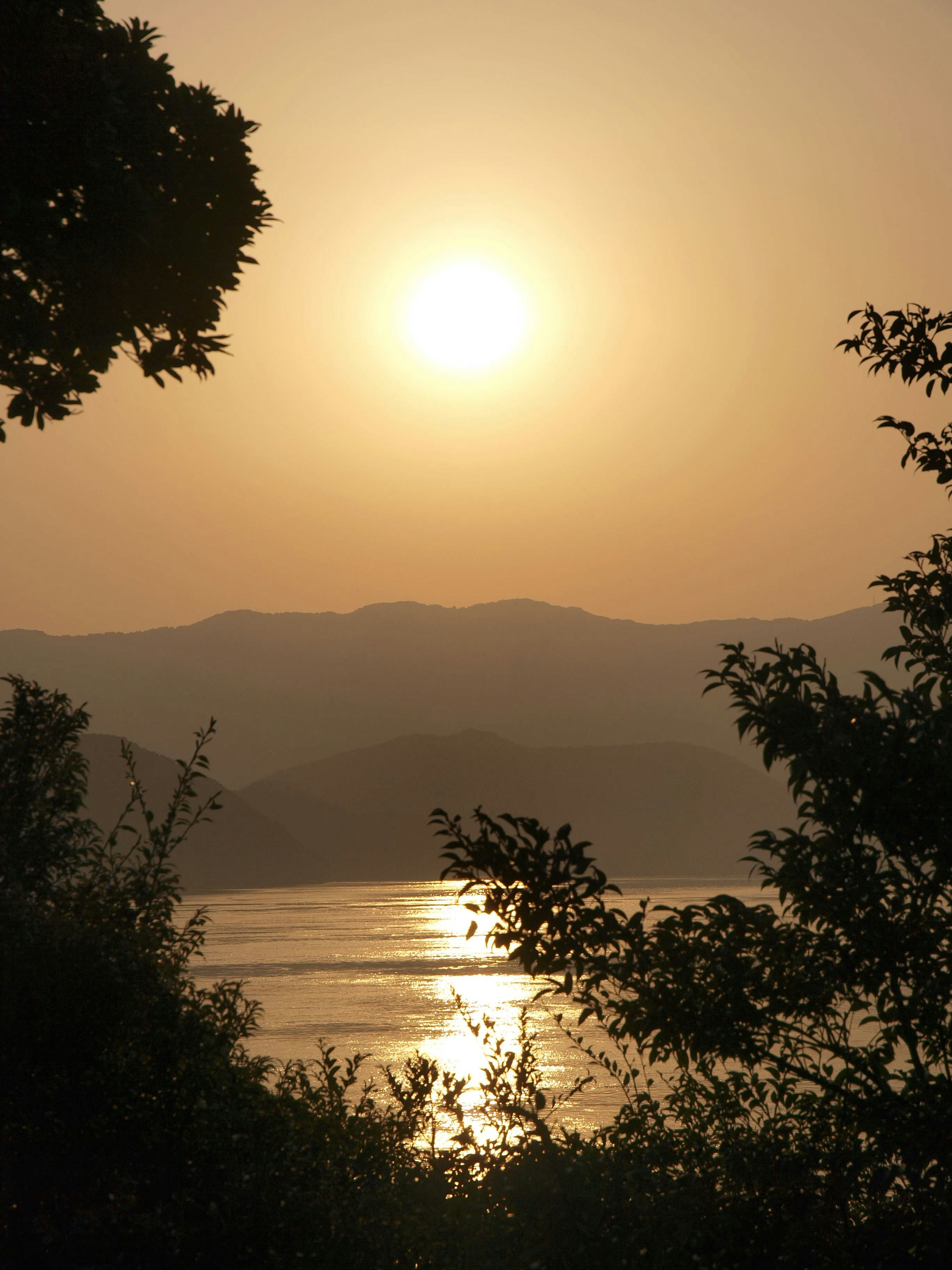 Tranquil lakeside landscape at sunset