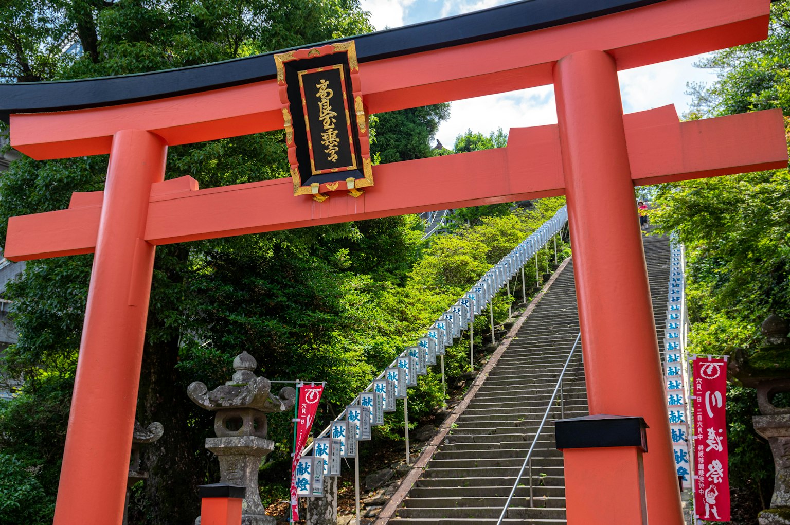 Red torii gate with stairs leading to a shrine