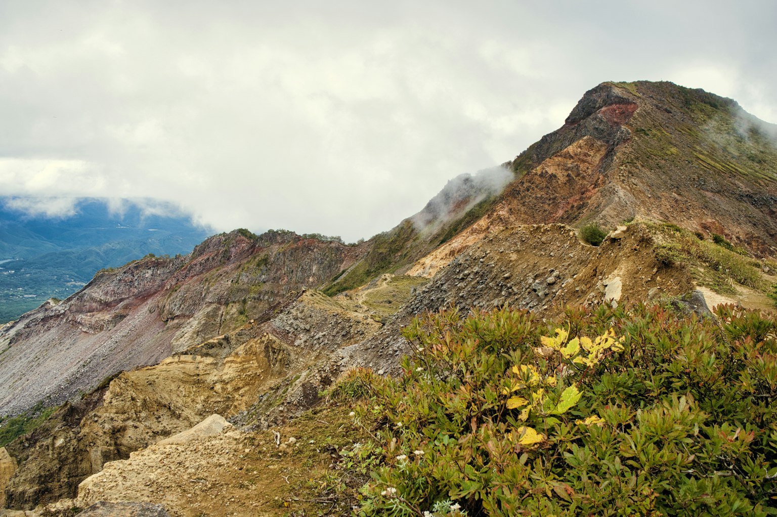 Photo of a mountain slope with a cloudy sky