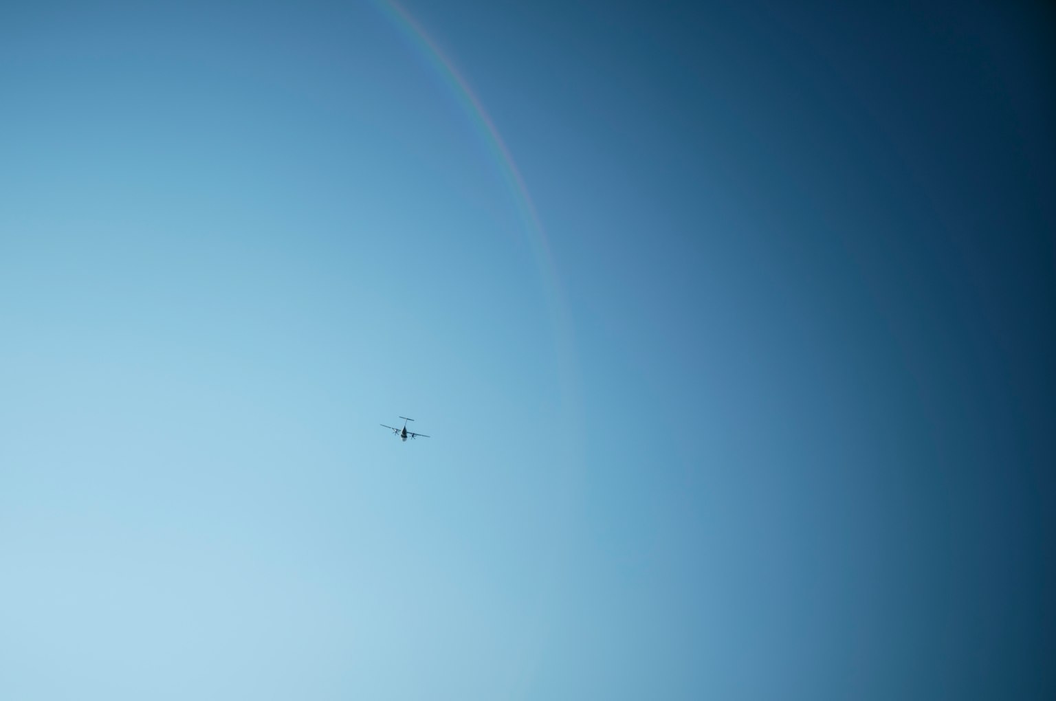 Silhouette of a small drone in the blue sky