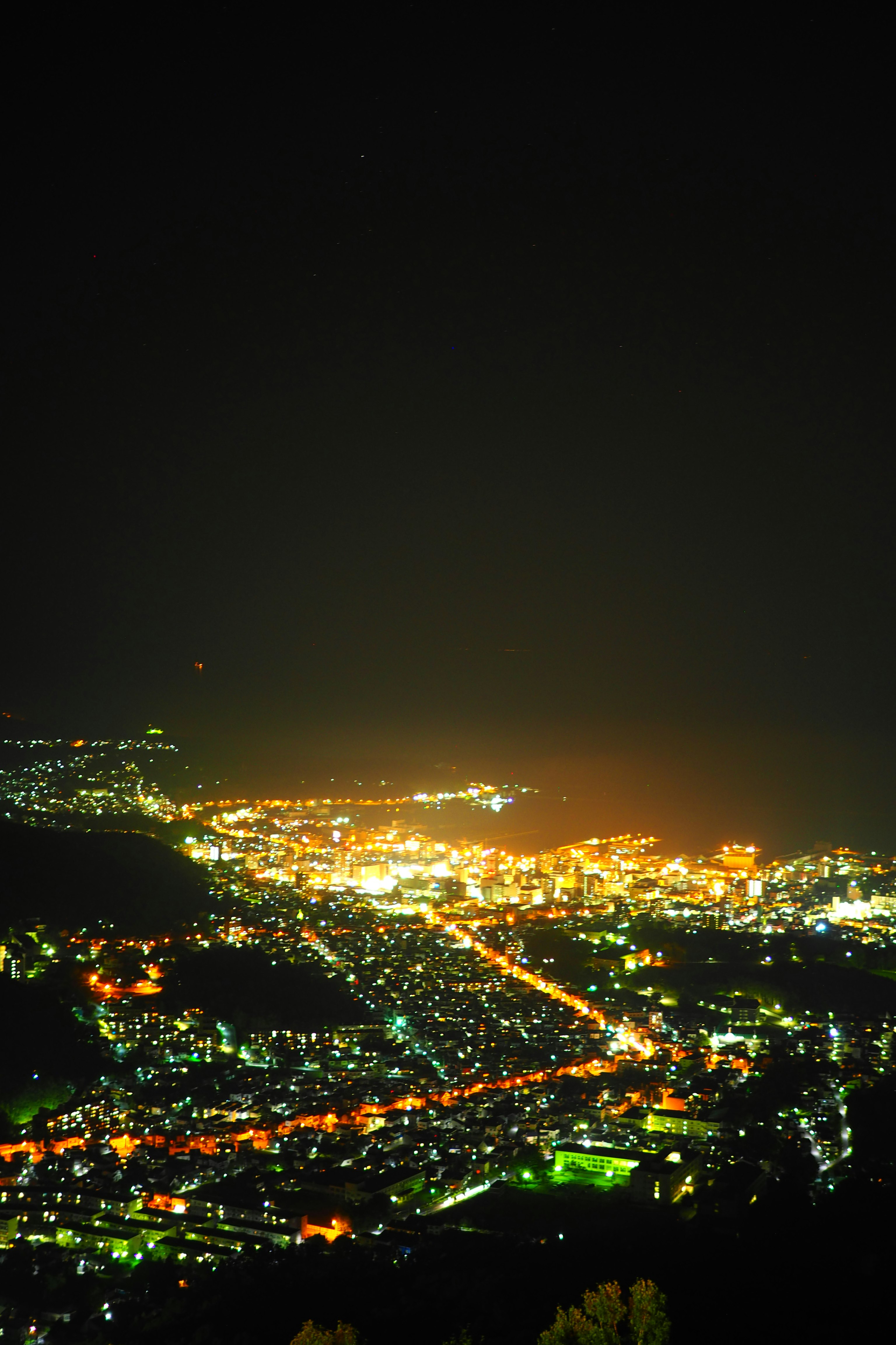 Stunning nighttime cityscape with bright lights and dark sky
