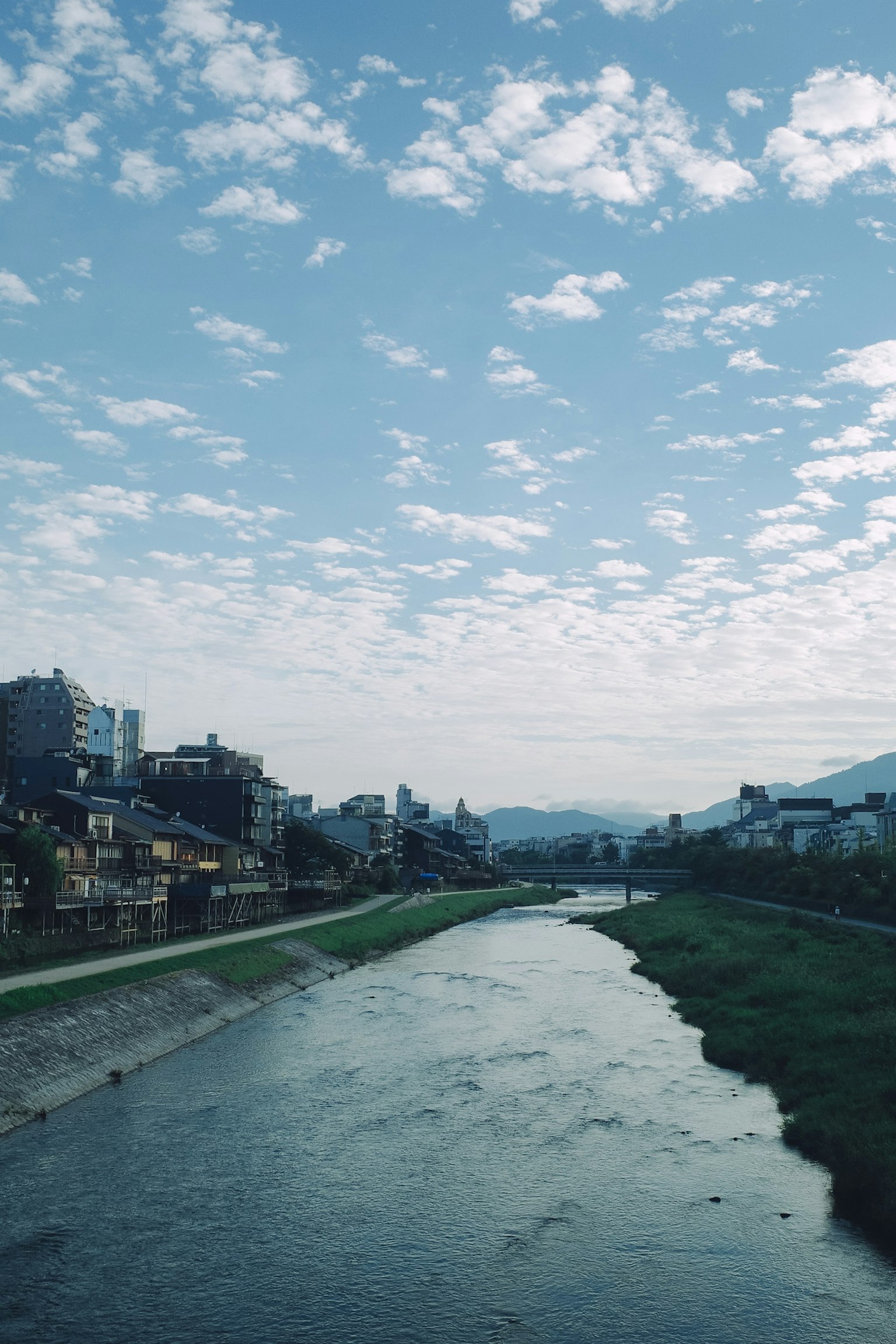 River landscape with blue sky and clouds along the shoreline