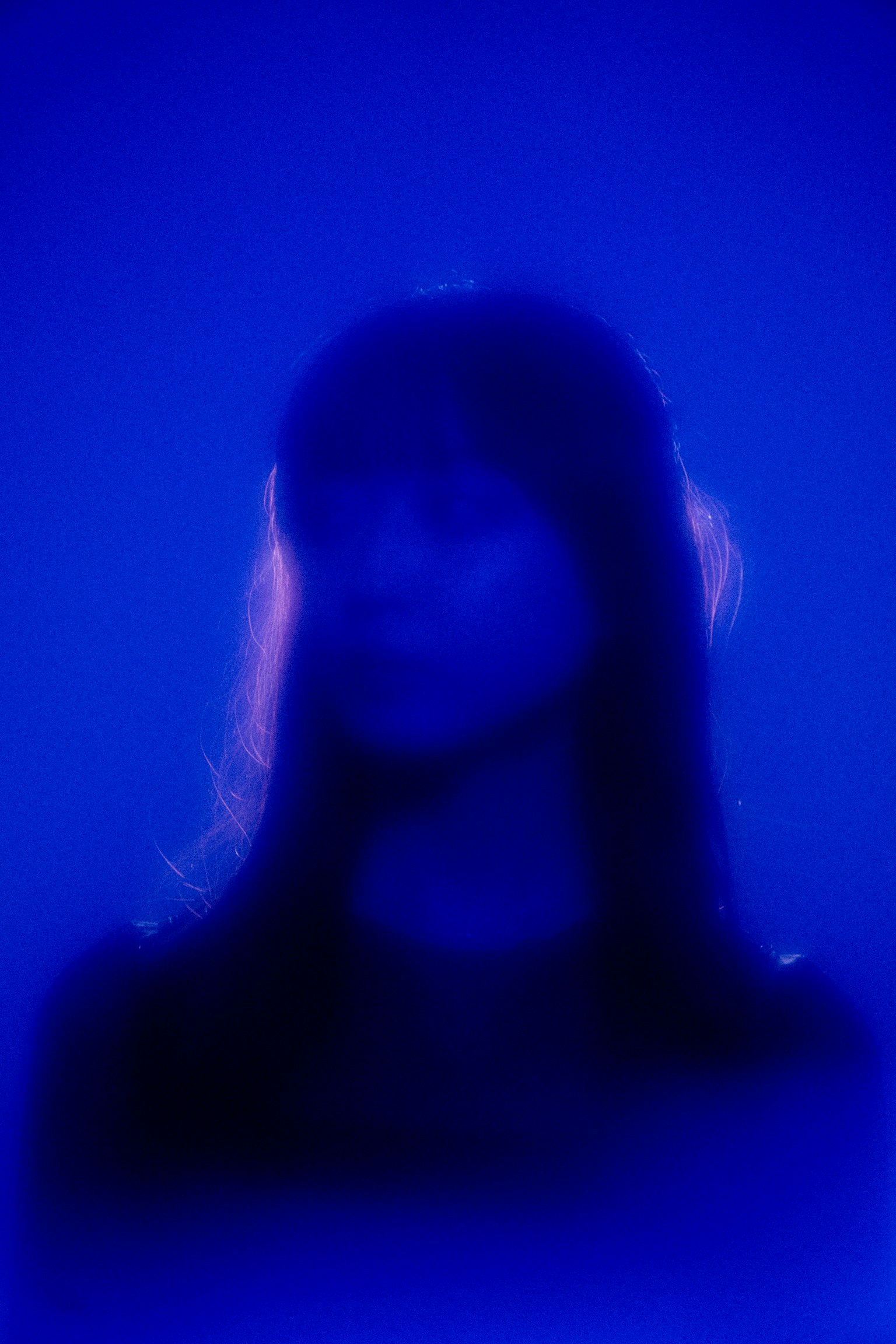 Silueta de una mujer iluminada por luz azul
