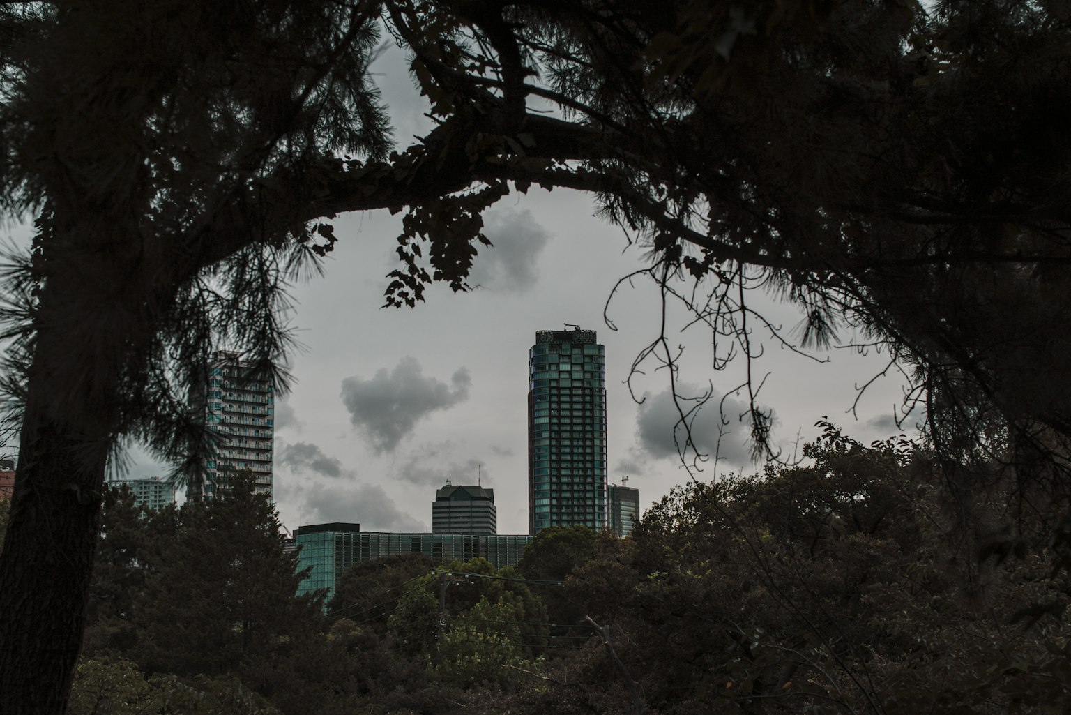 Image of a city skyline with dark clouds overhead