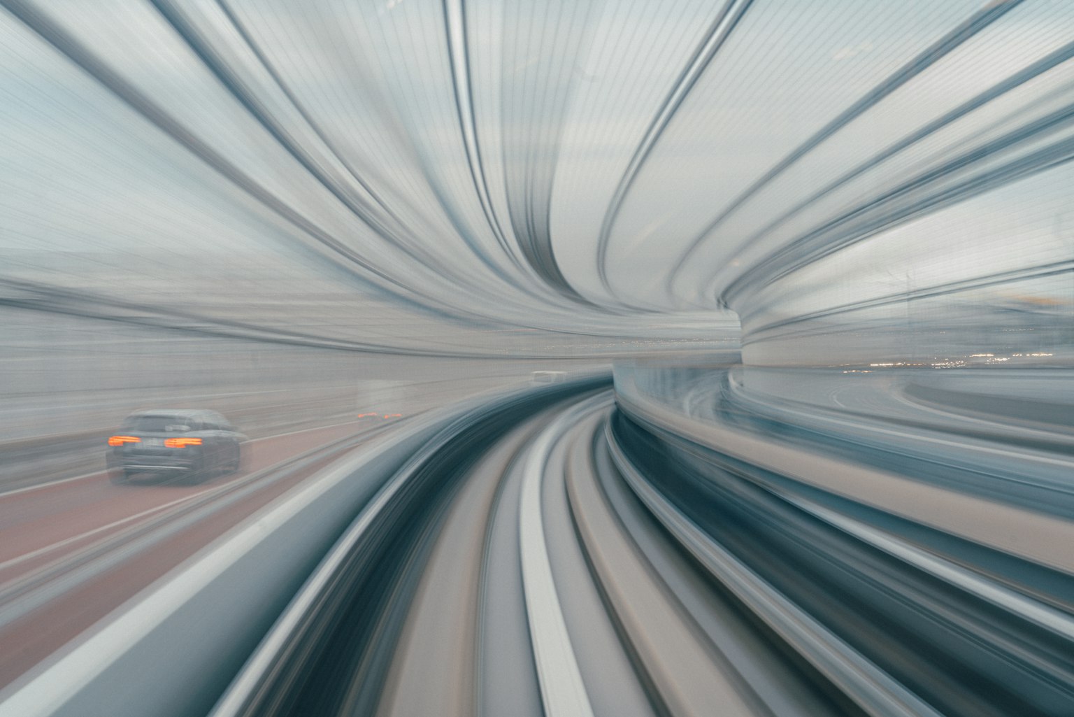 Abstract cityscape featuring a moving vehicle and curved tracks