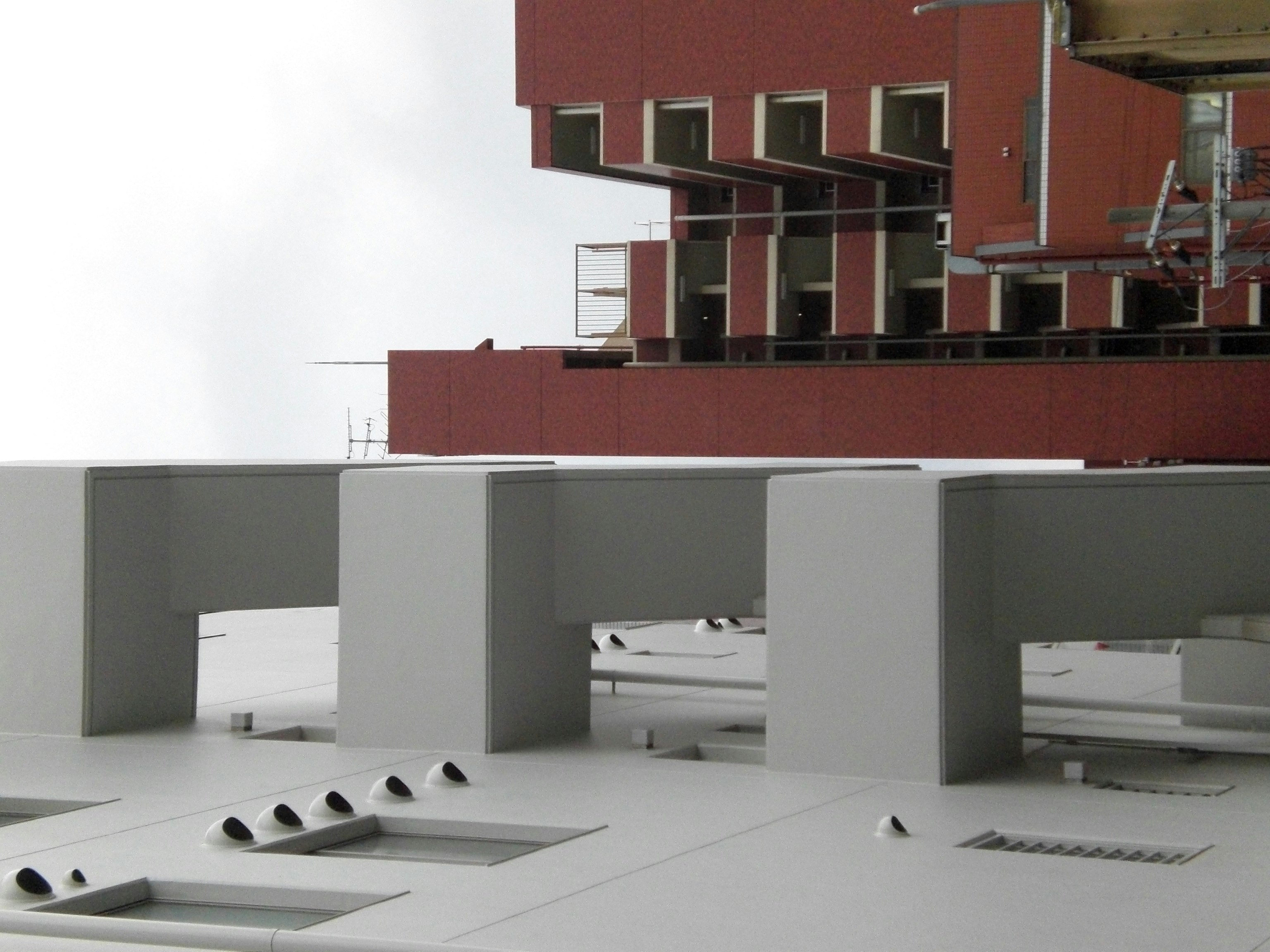 architectural model and desks on a white floor