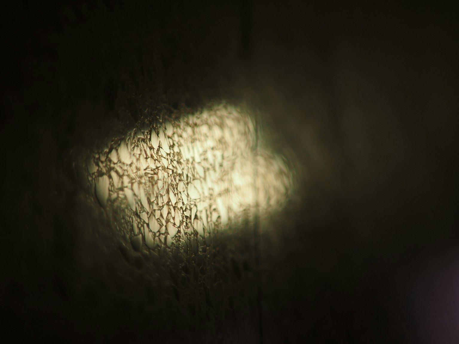 Faint reflection of light on a dark surface