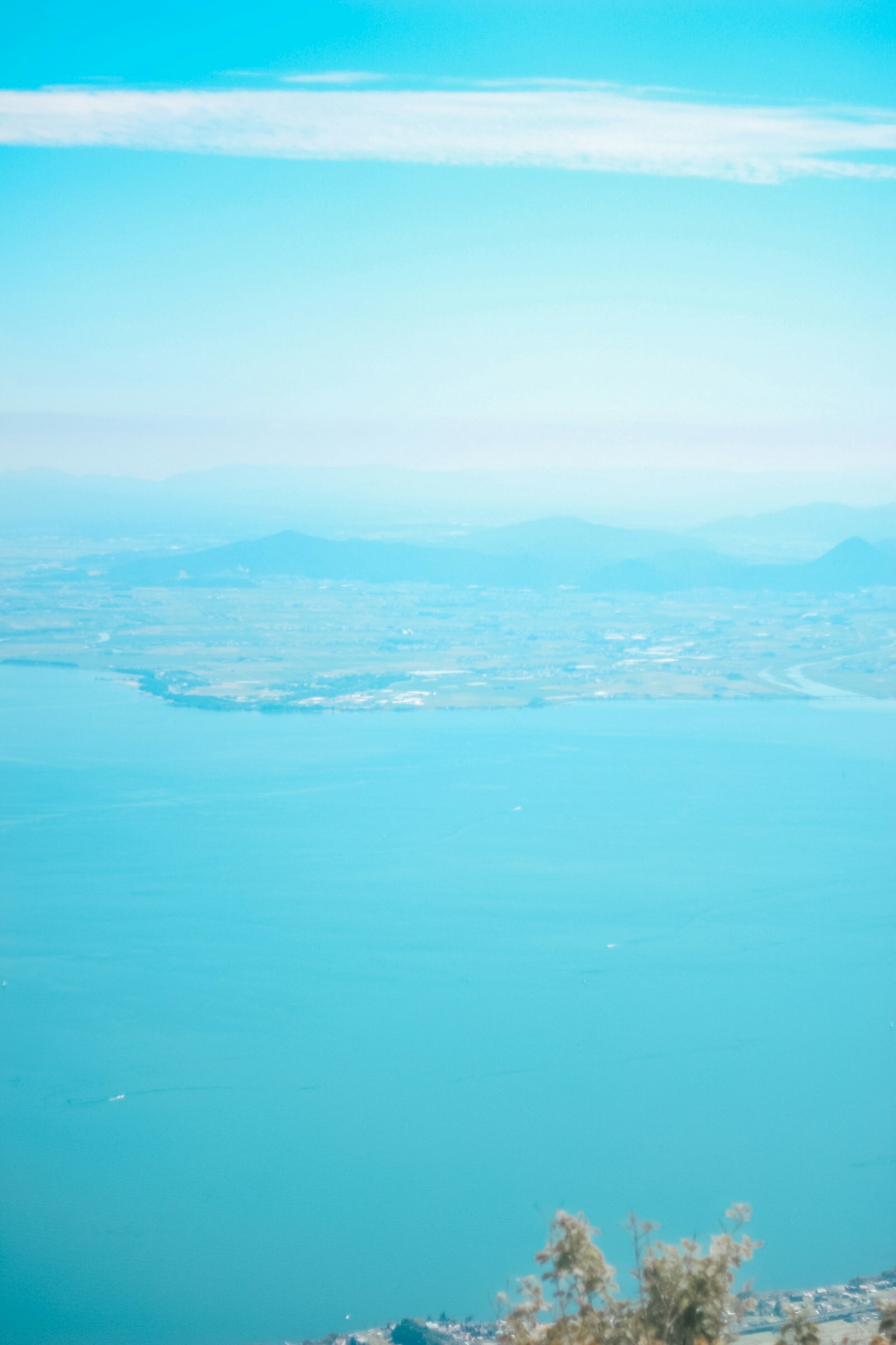 A view from the mountaintop featuring blue sea and sky
