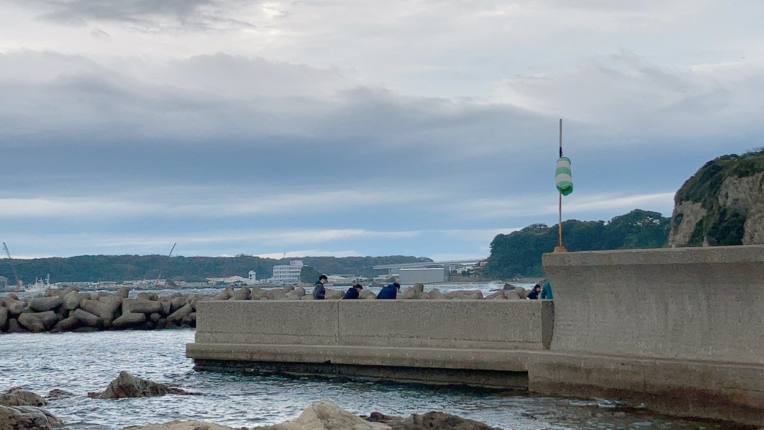 Coastal breakwater with a cloudy sky