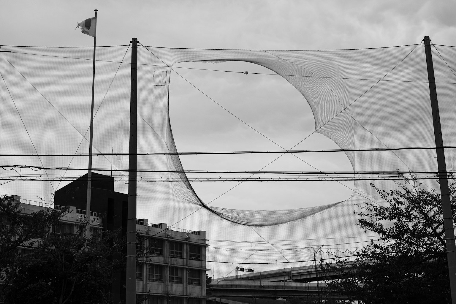 A heart-shaped net against a monochrome urban backdrop