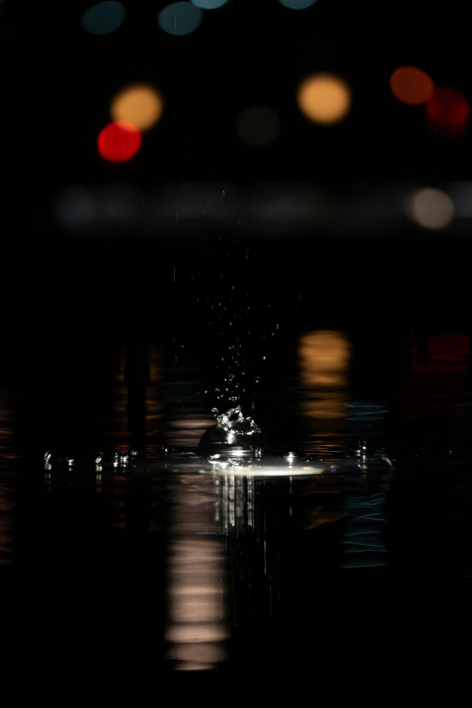 A moment capturing the impact and splash of a droplet on the water surface