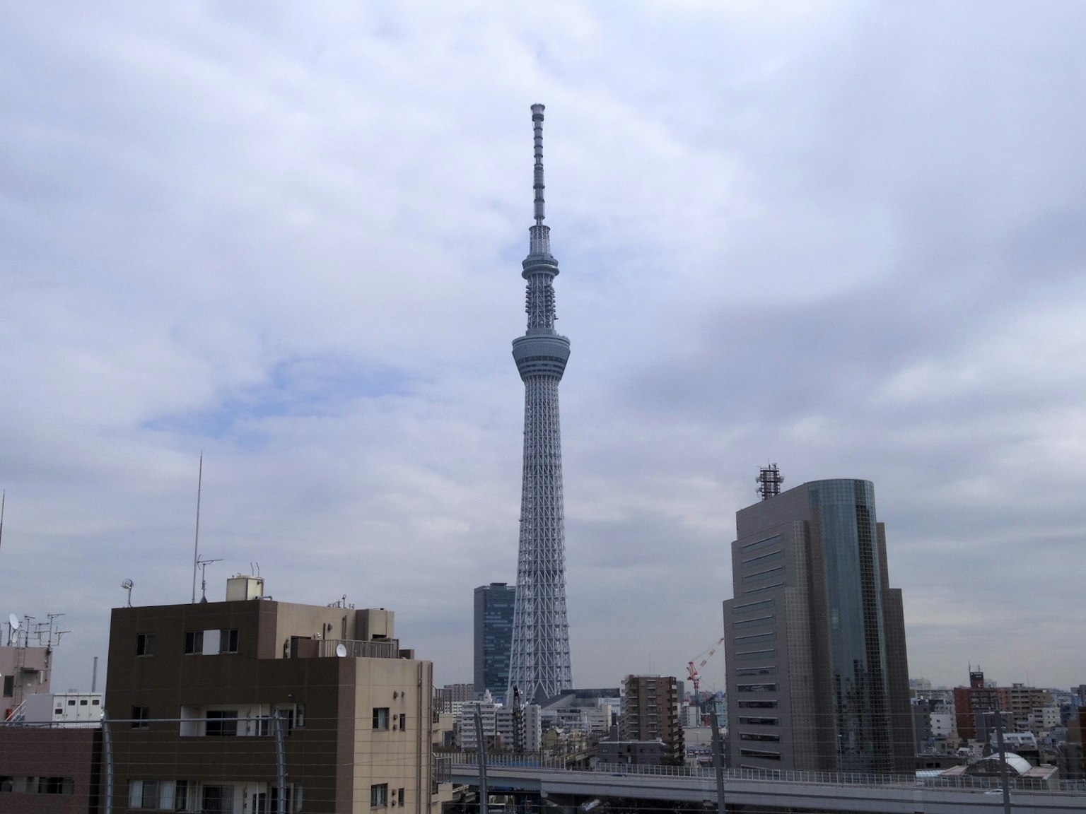 Tokyo Skytree towering over the city skyline under a blue sky