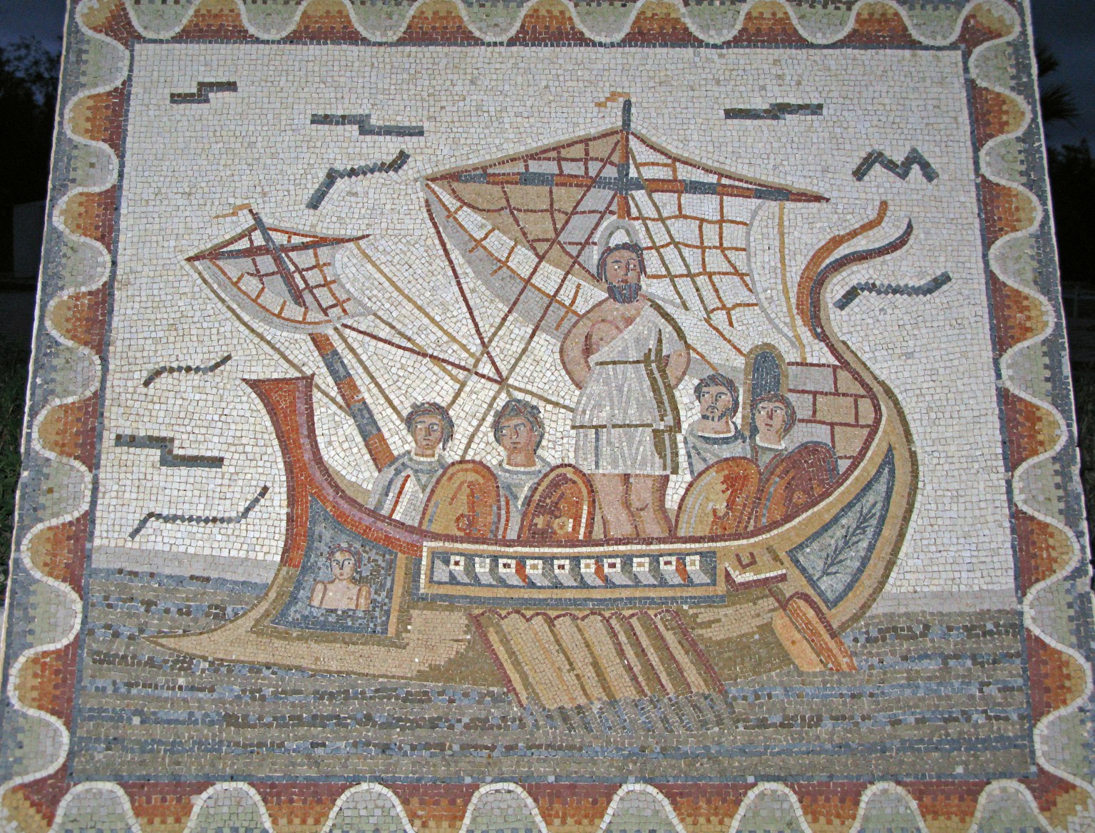 Antike Mosaikdarstellung eines Schiffs mit einer stehenden Figur und Besatzungsmitgliedern