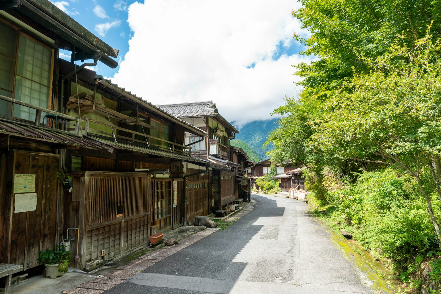 Quiet street lined with traditional wooden houses and blue sky