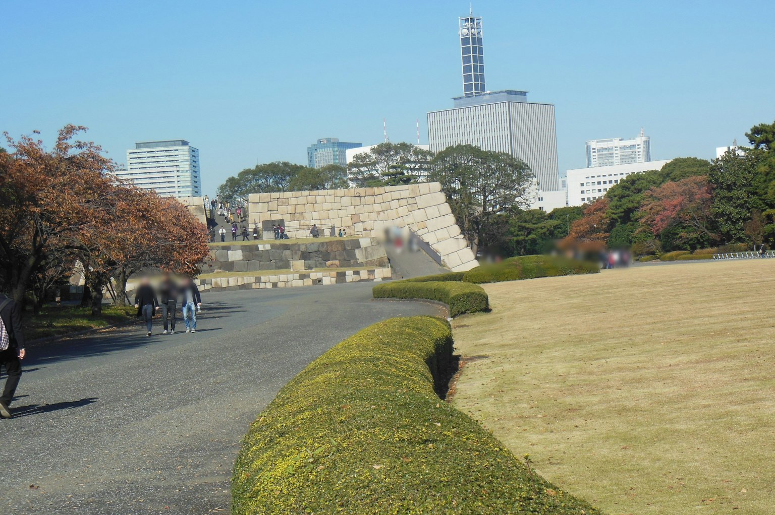 Stone structure in a Tokyo park surrounded by green landscape