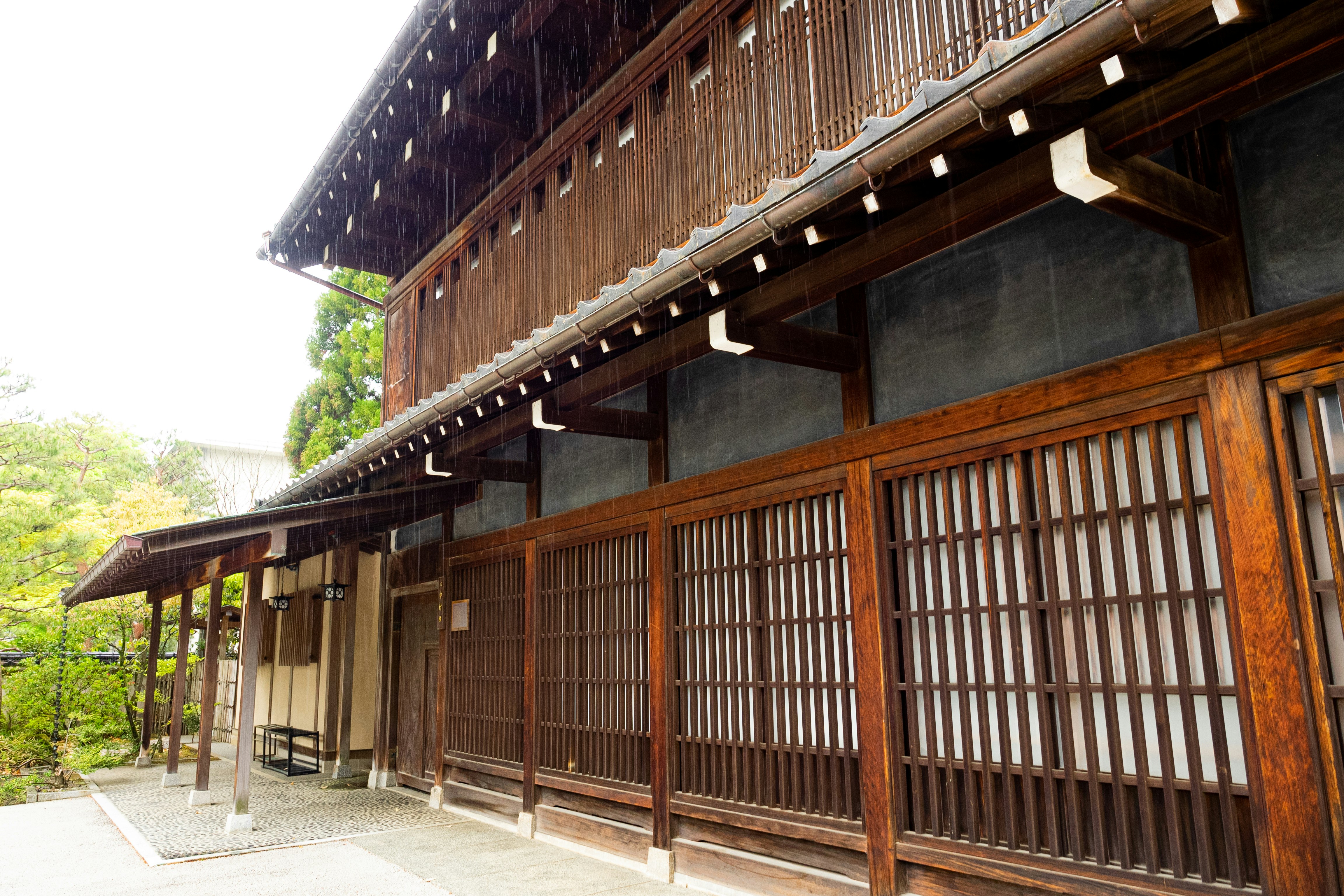 Exterior of an old wooden building with a long corridor and lattice doors