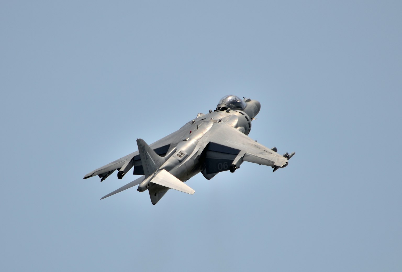 Military jet flying high in the sky from a rear view