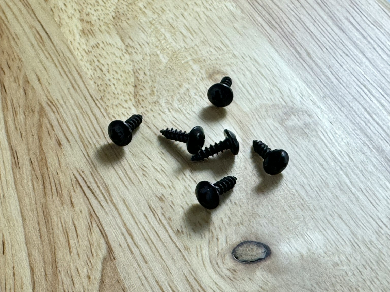 木桌上的黑色螺丝集合