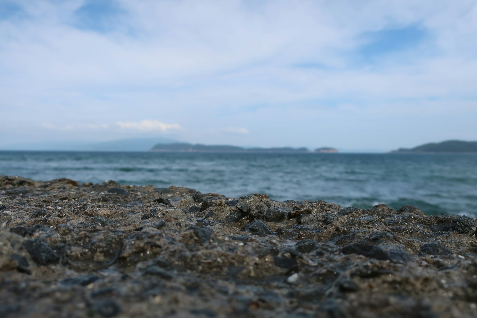 Coastal rocks with a blue ocean and cloudy sky