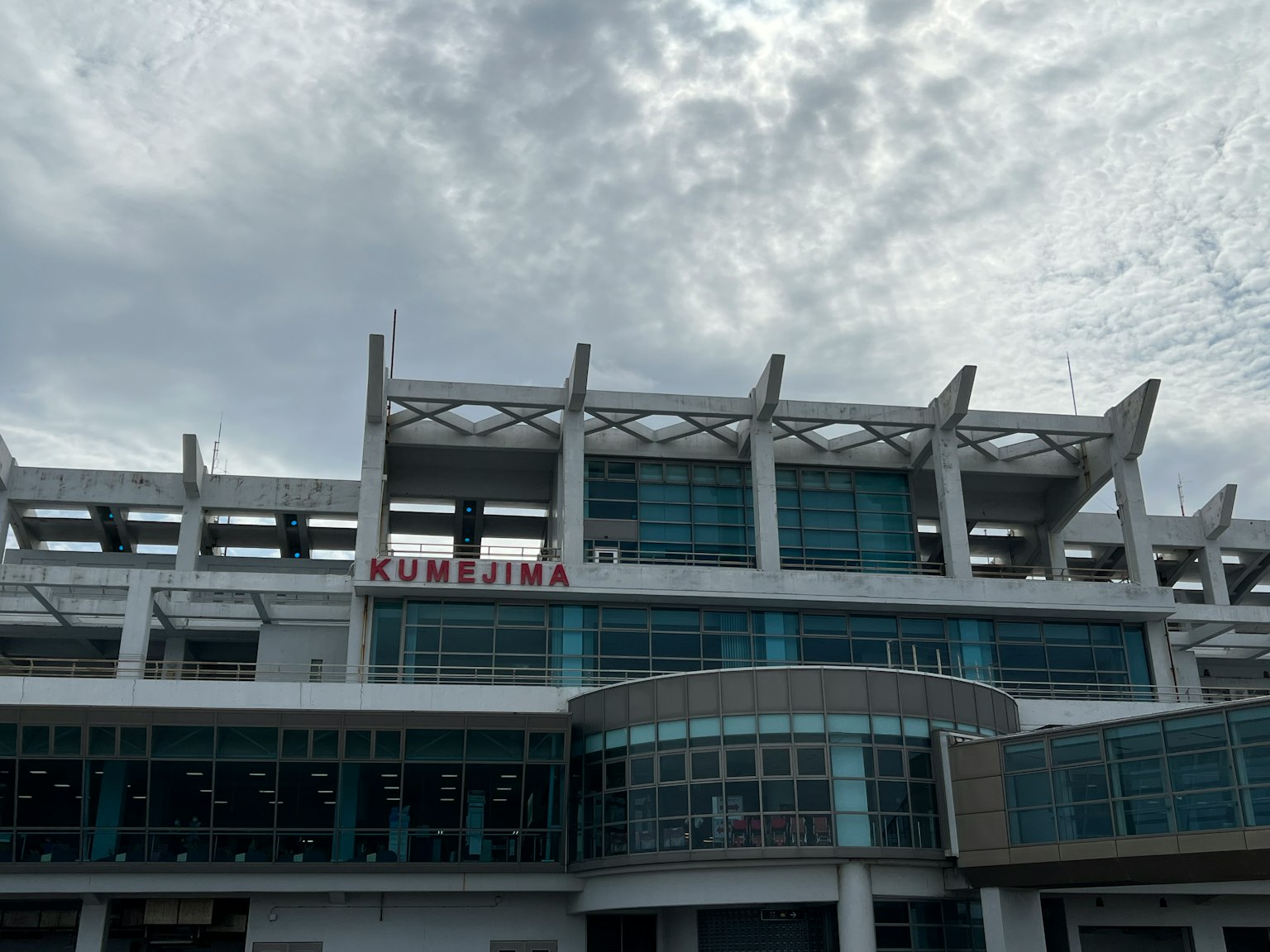 Modern building facade with large windows and unique roof design