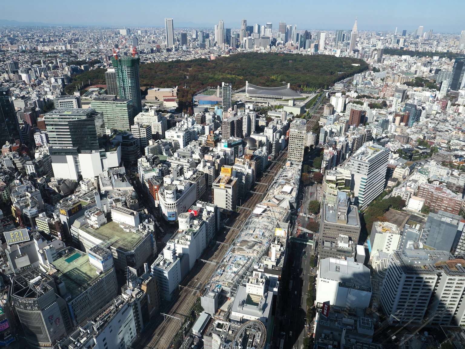 Aerial view of Tokyo showcasing skyscrapers and a green park