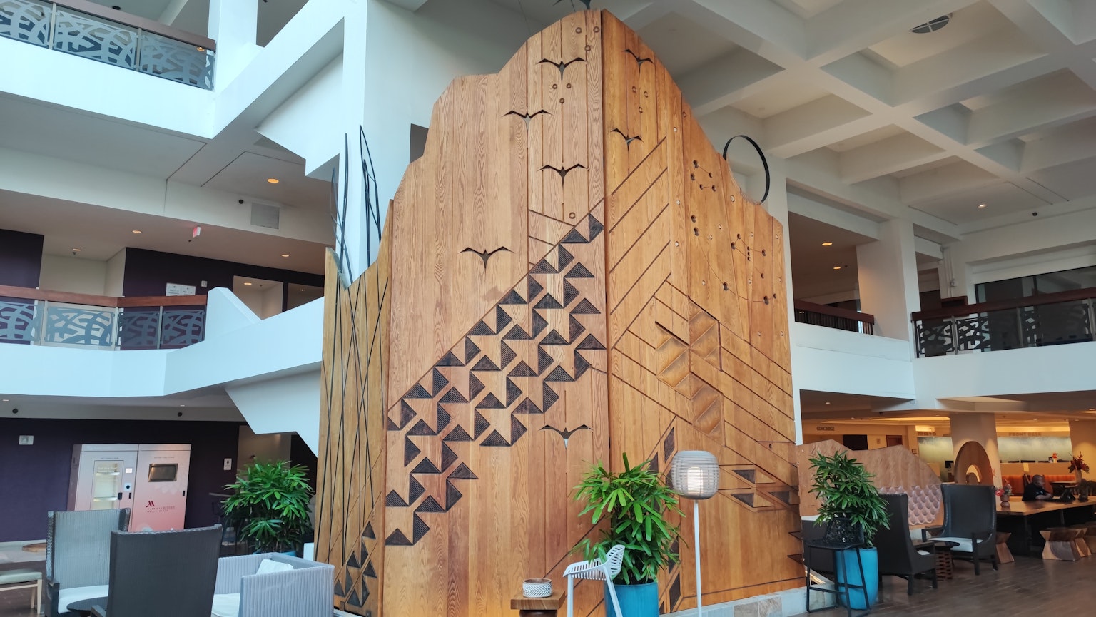 Interior lobby with decorative wooden wall featuring geometric patterns