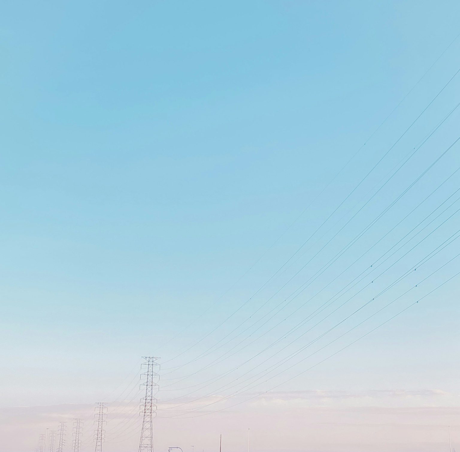 Landscape featuring a blue sky and power lines