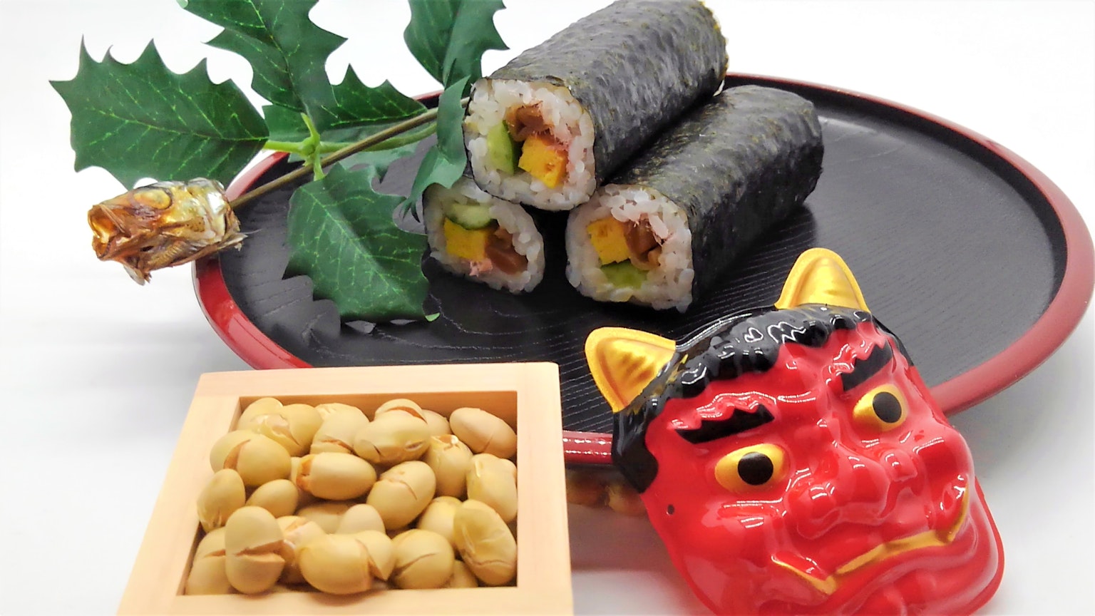 Rouleaux de sushi avec un masque de démon rouge et des fèves de soja grillées