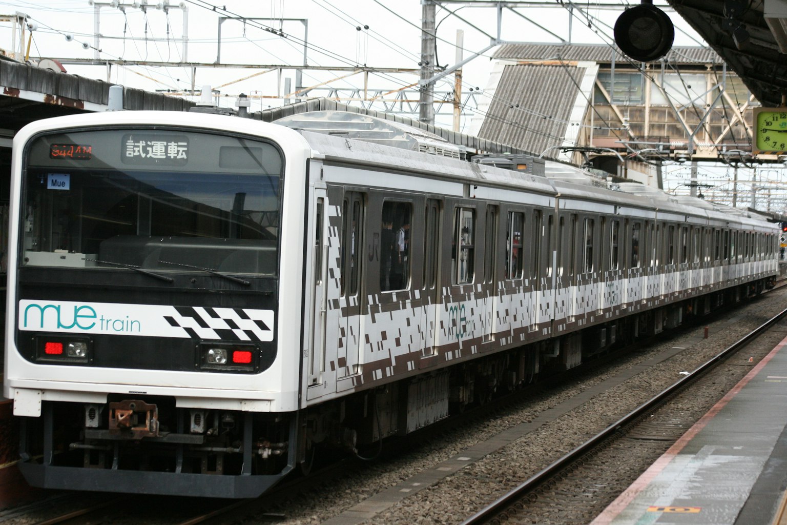 A white train parked at a station