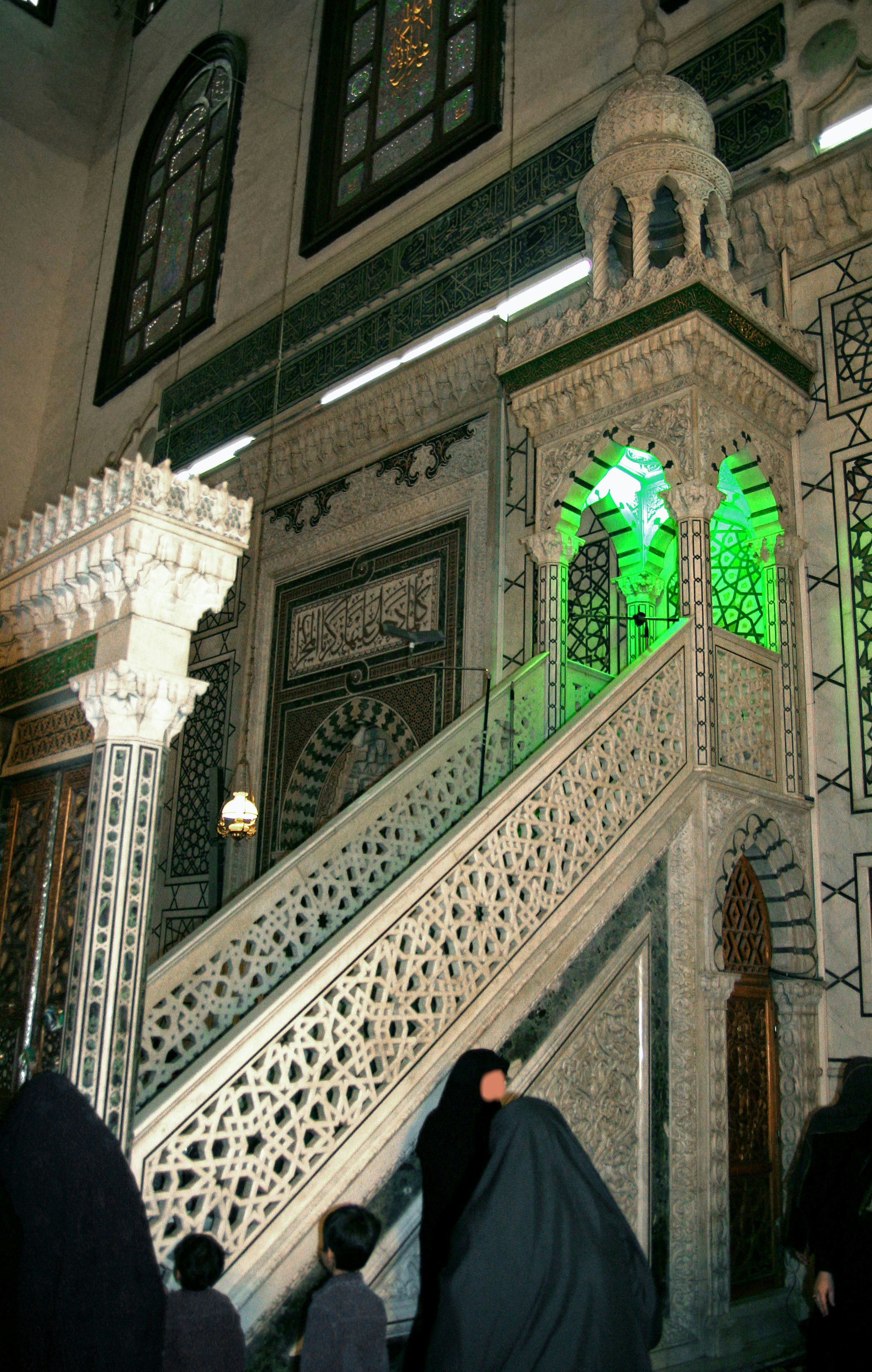 Mosque wall with ornate green arches