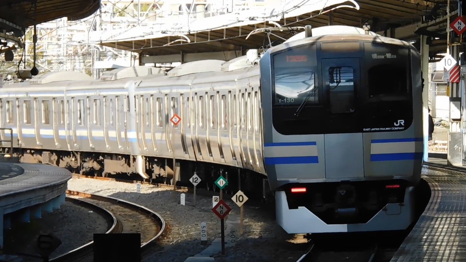 Silver train arriving at a station