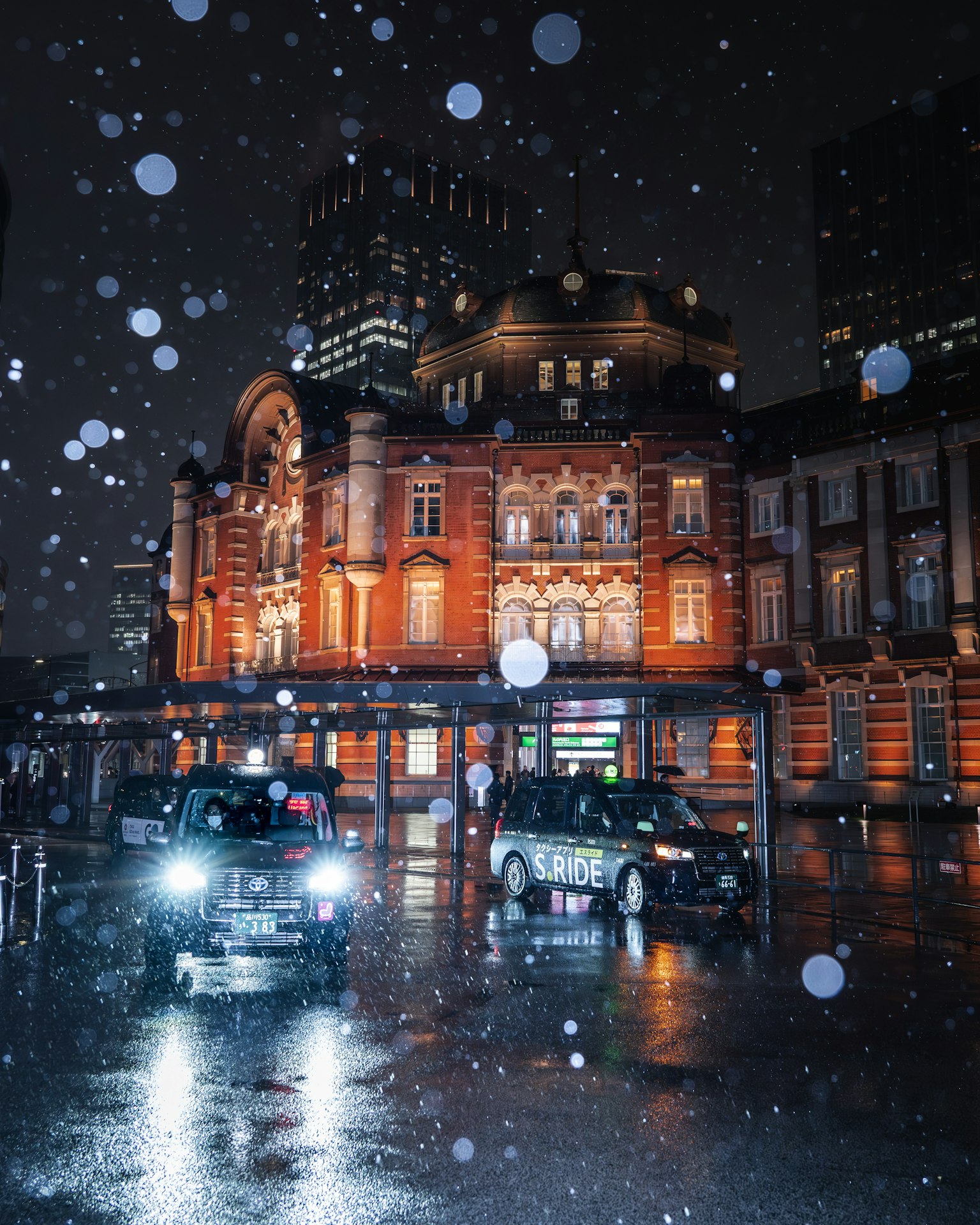 Beautiful Tokyo Station building at night with falling snow